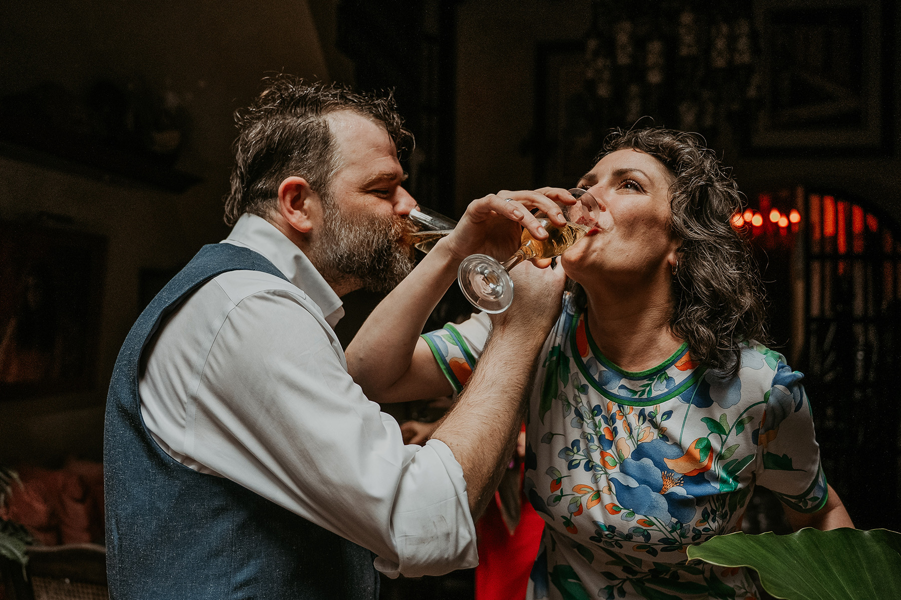 Joyful candid wedding moment celebrating with champagne after intimate ceremony