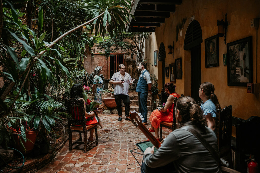 Intimate elopement ceremony at Gallery Inn Old San Juan with close friends and live guitar music.