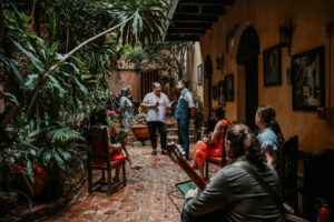 Intimate elopement ceremony at Gallery Inn Old San Juan with close friends and live guitar music.
