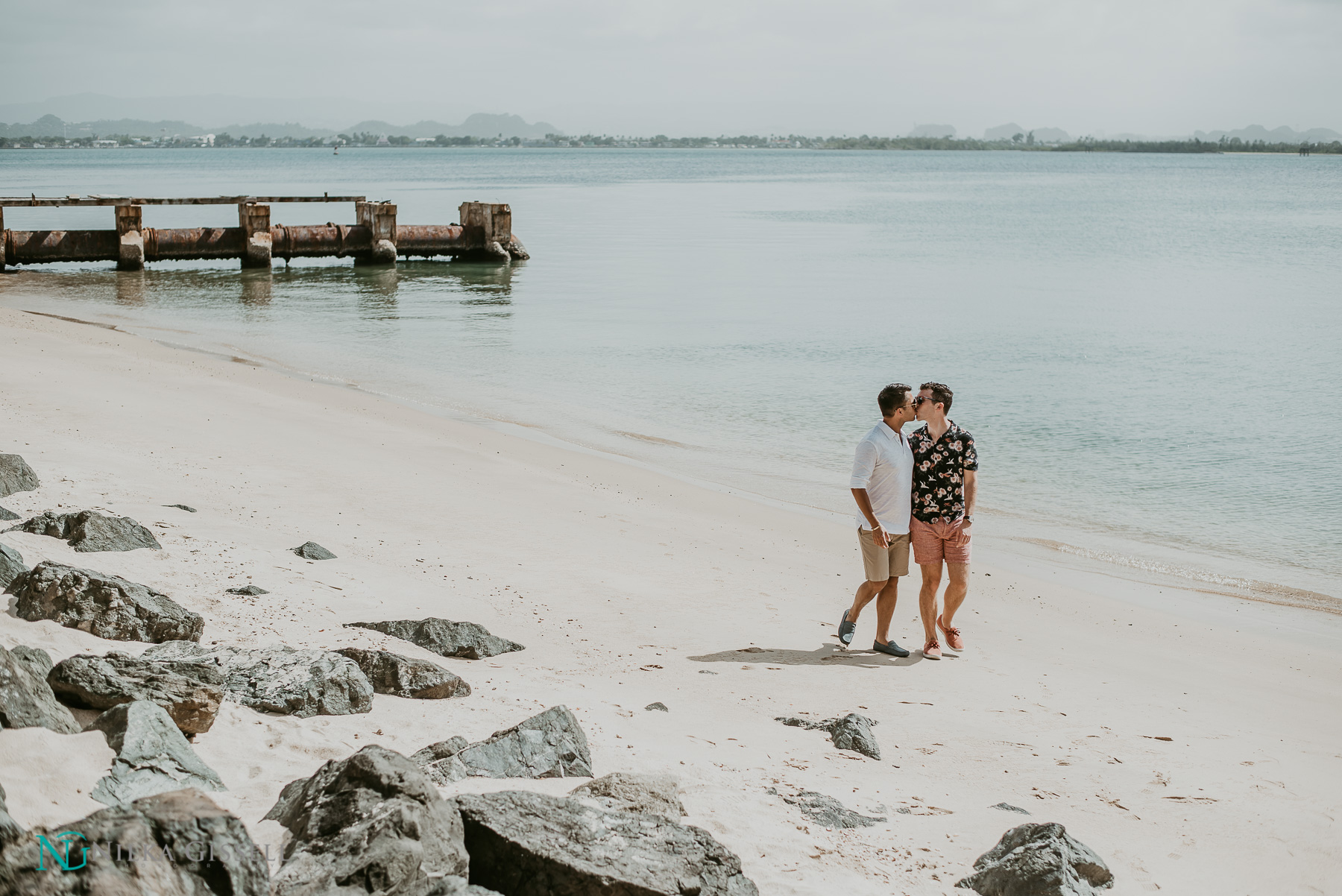 LGBTQ+ couple walking on the beach at Old San Juan Puerto Rico.