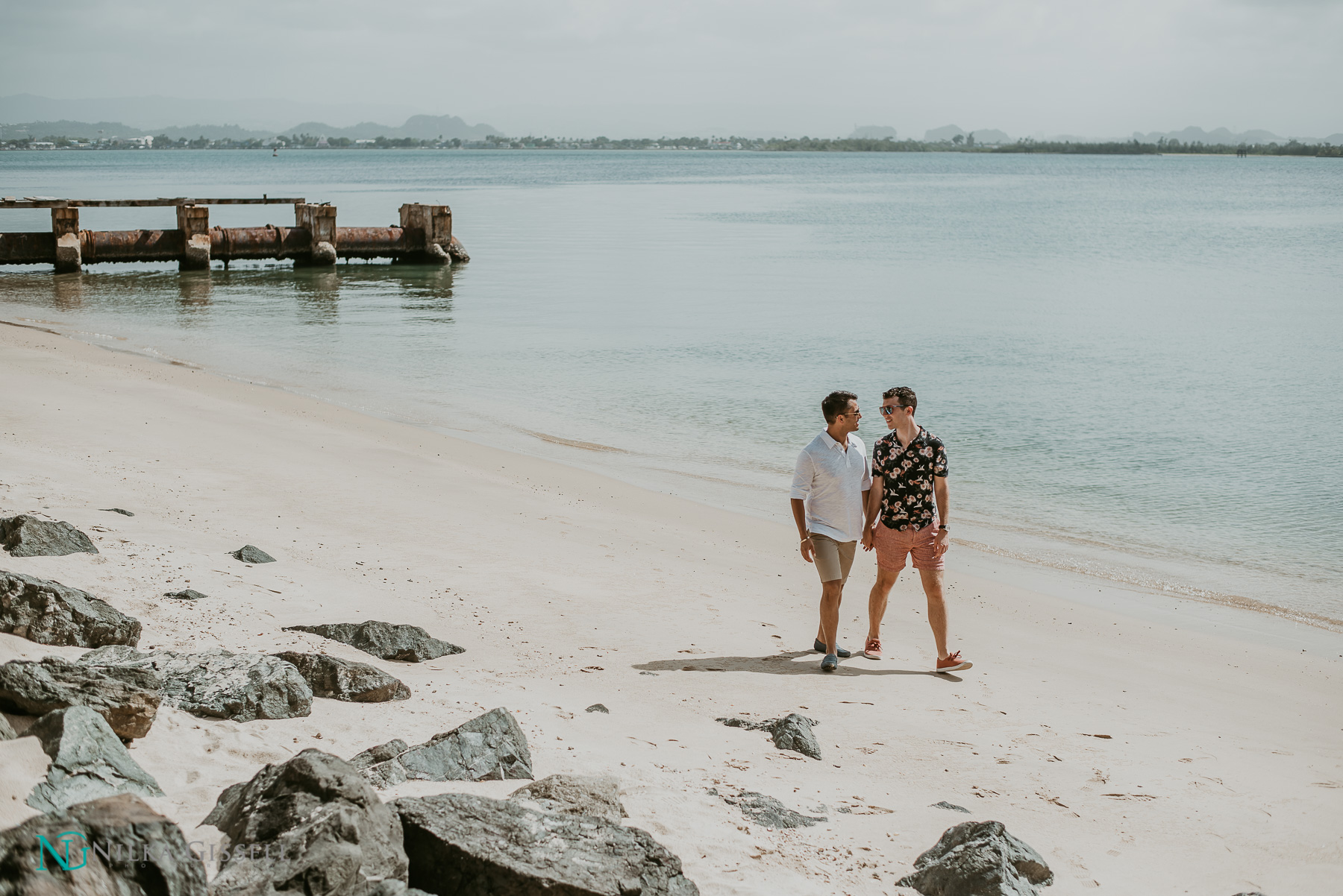 Gay couple waking on the beach at Old San Juan Engagement Session.