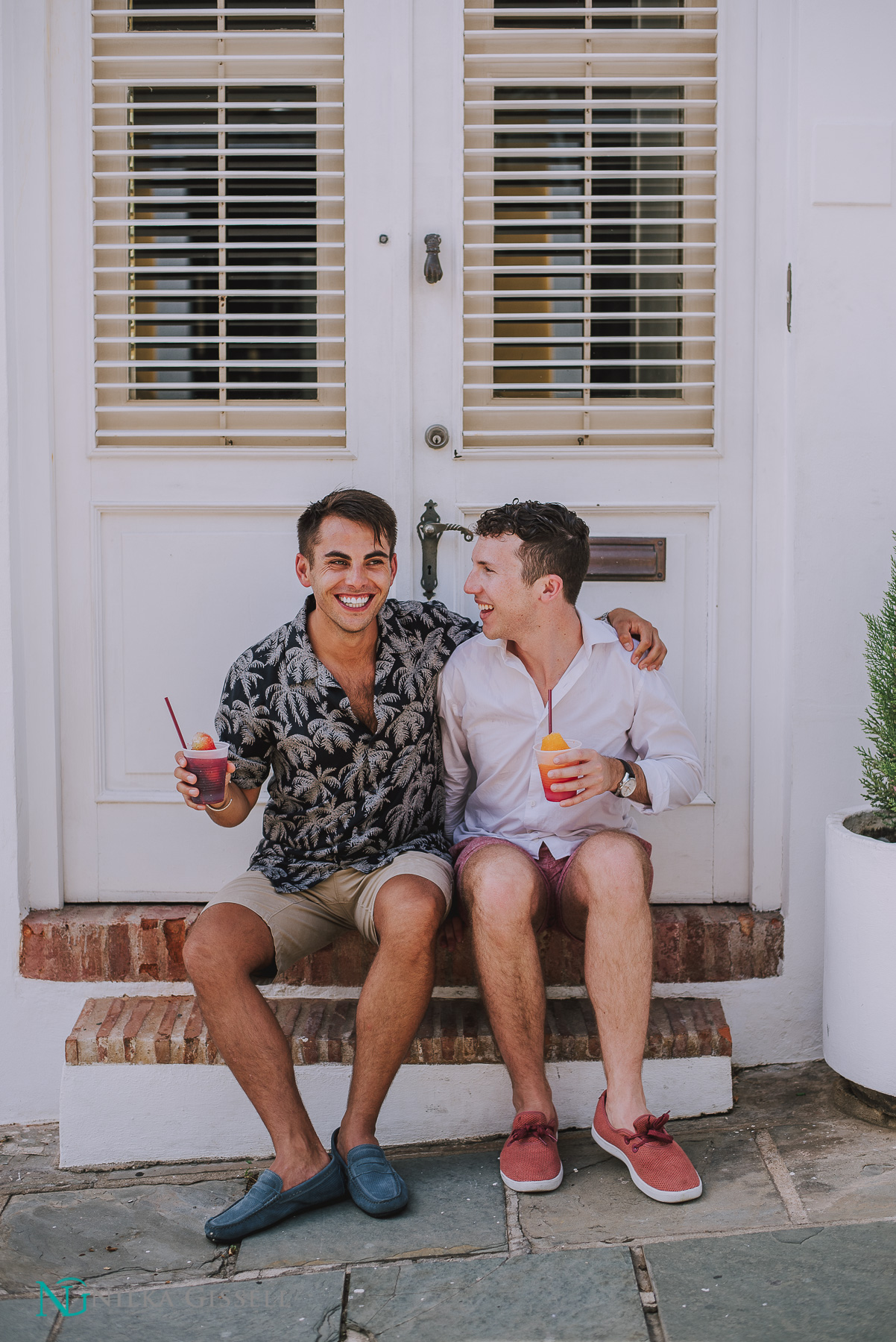 LGBTQ+ Couple sitting eating piragua during their engagement at Old San Juan.