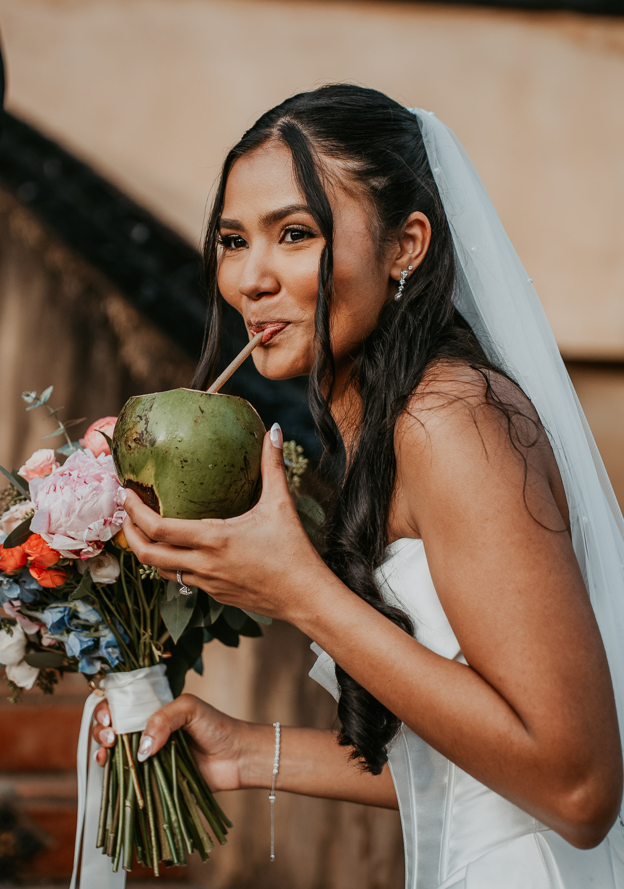 Bride drinks coconut water in a Puerto Rico wedding at Hacienda Campo Rico.