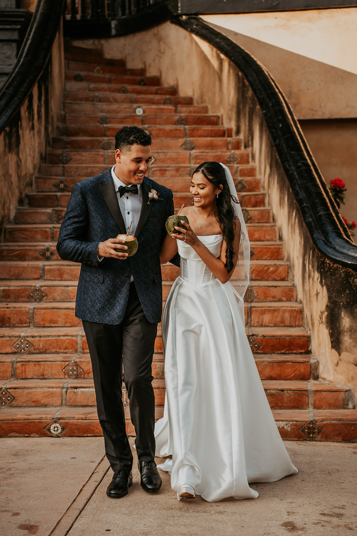 Candid wedding portraits in Spanish style courtyard.