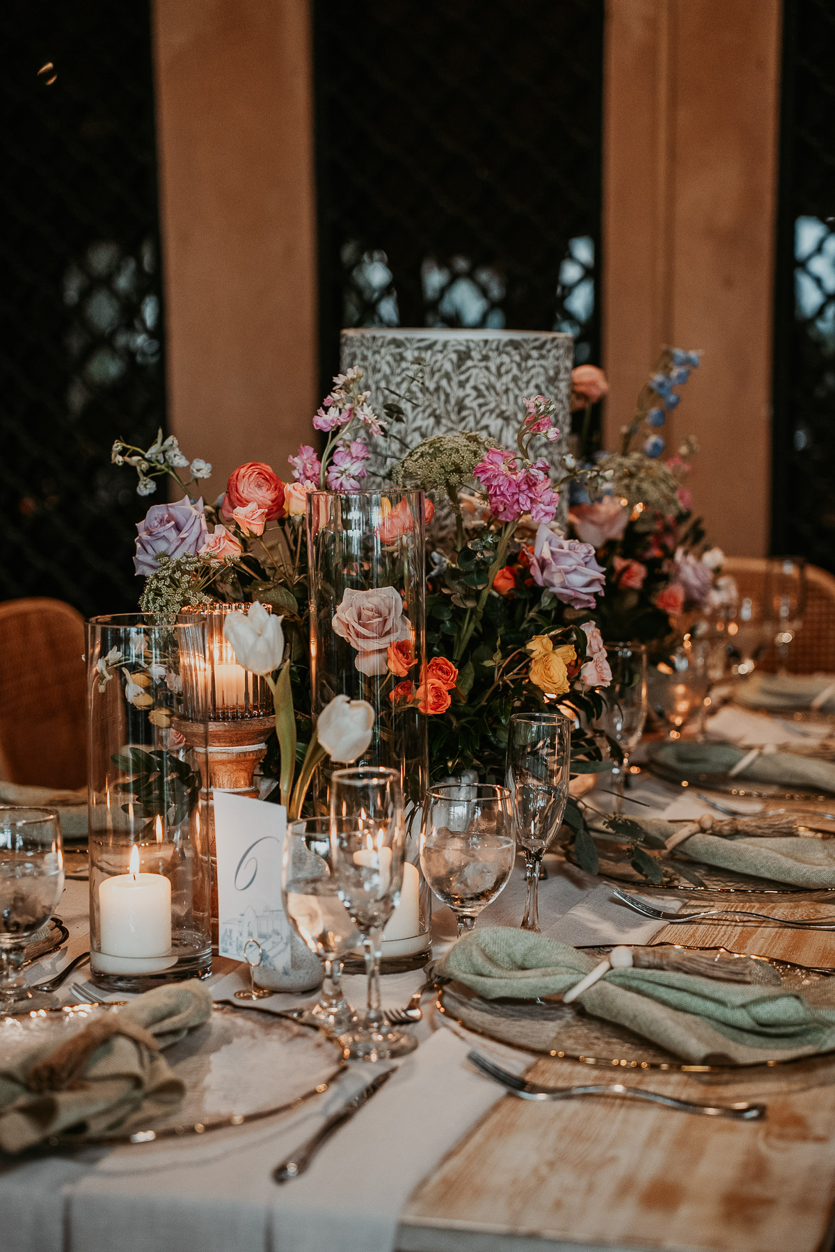 Elegant wedding reception tablescape at Campo Rico with candles and greenery.