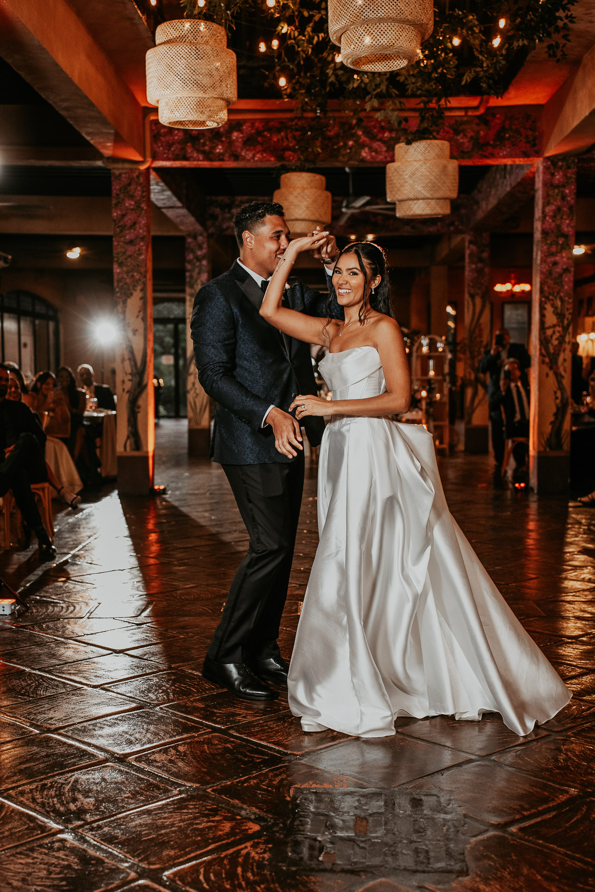Bride and groom dancing under string lights at Campo Rico wedding reception.