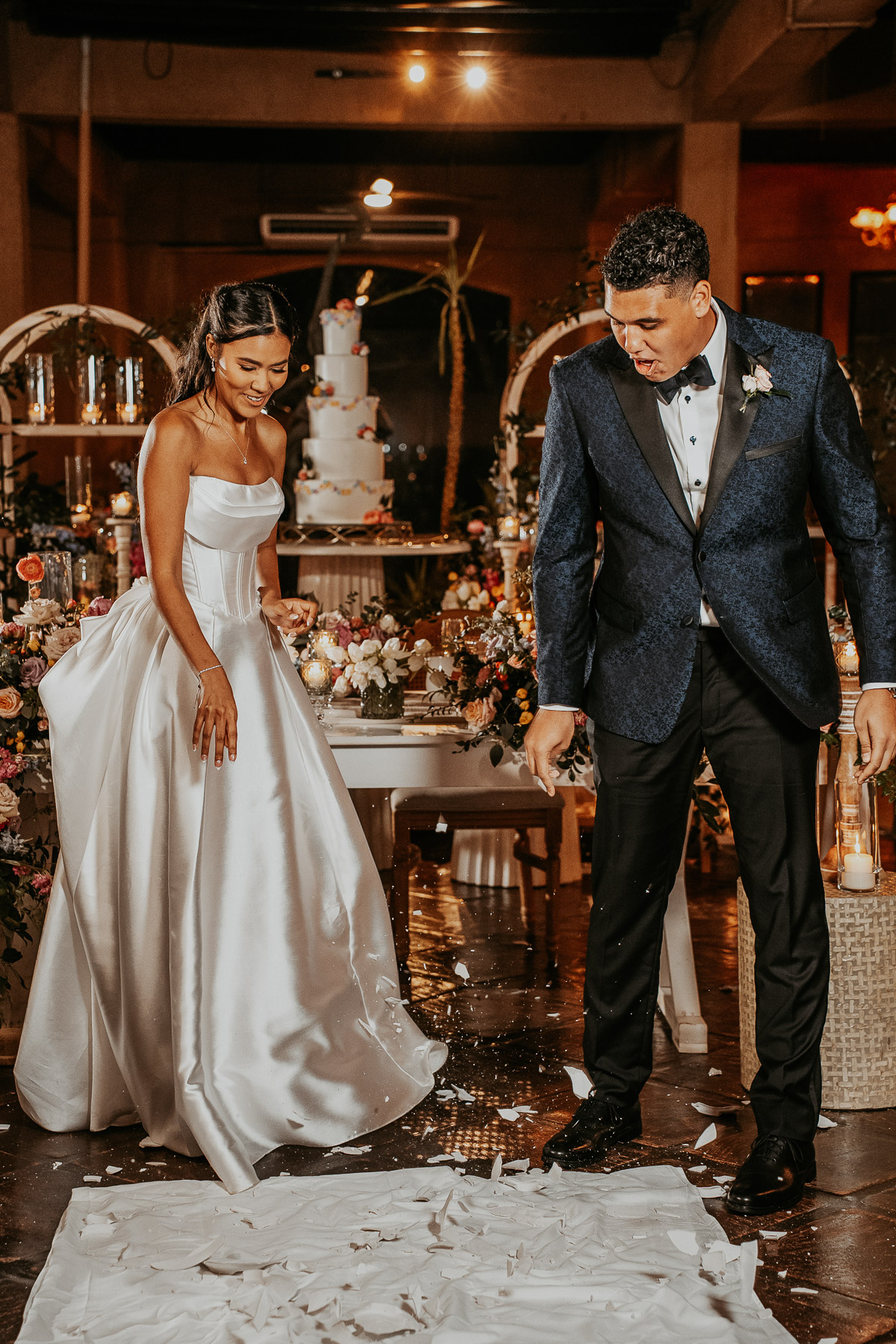 Couple smashing plates during wedding celebration at Puerto Rico hacienda venue.