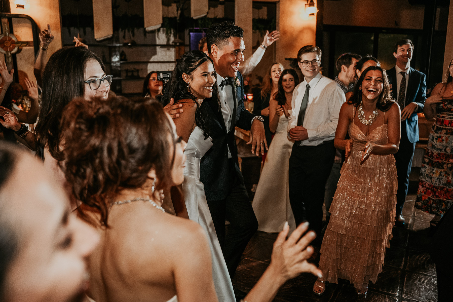Bride and groom celebrating with friends at Puerto Rico hacienda reception.