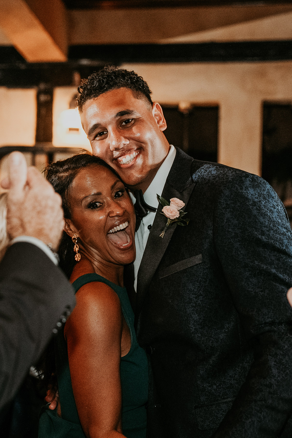 Groom dancing with his mother during lively Hacienda Campo Rico wedding reception.