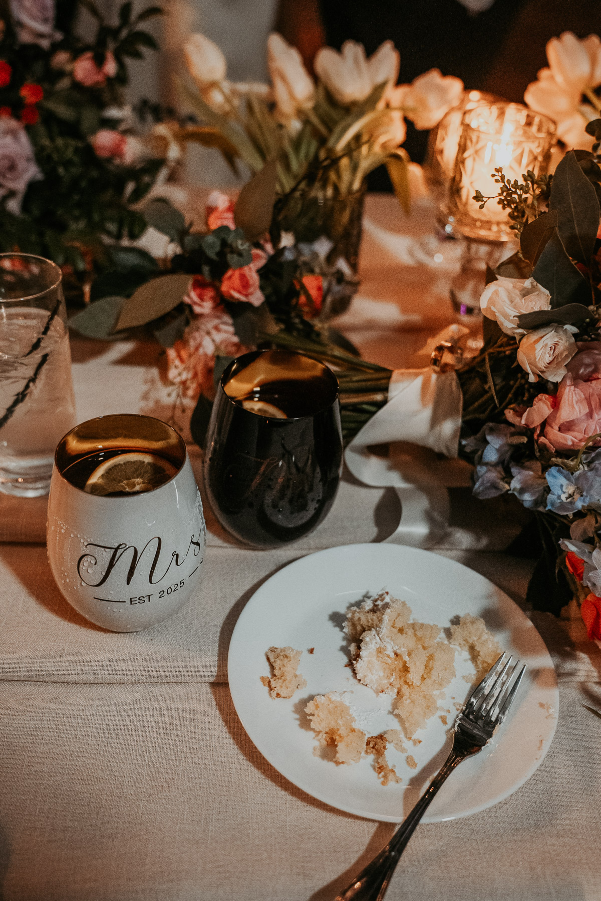 Wedding detail flat lay with cake, mugs and florals.