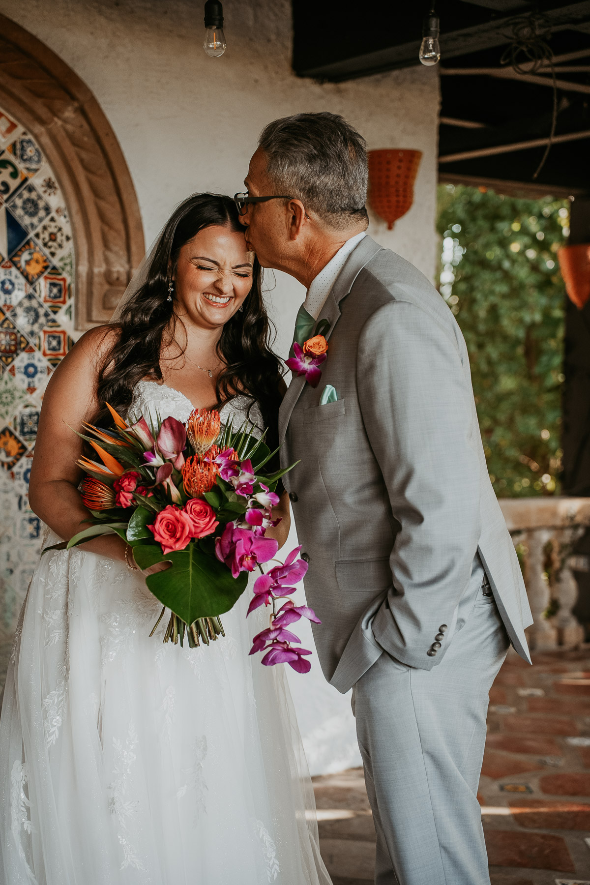 Candid and tender moment of bride with father-daughter first look