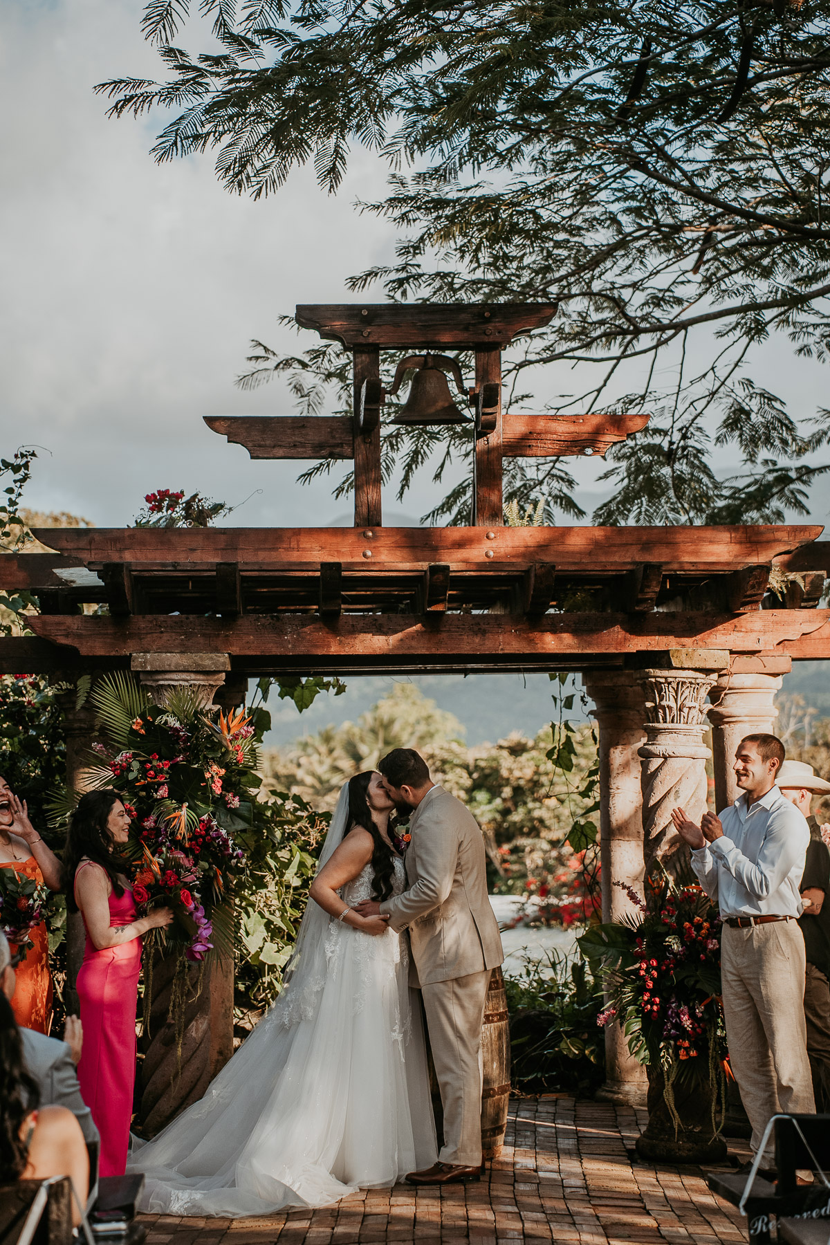 Wide shot of couple sharing their first kiss as newlyweds