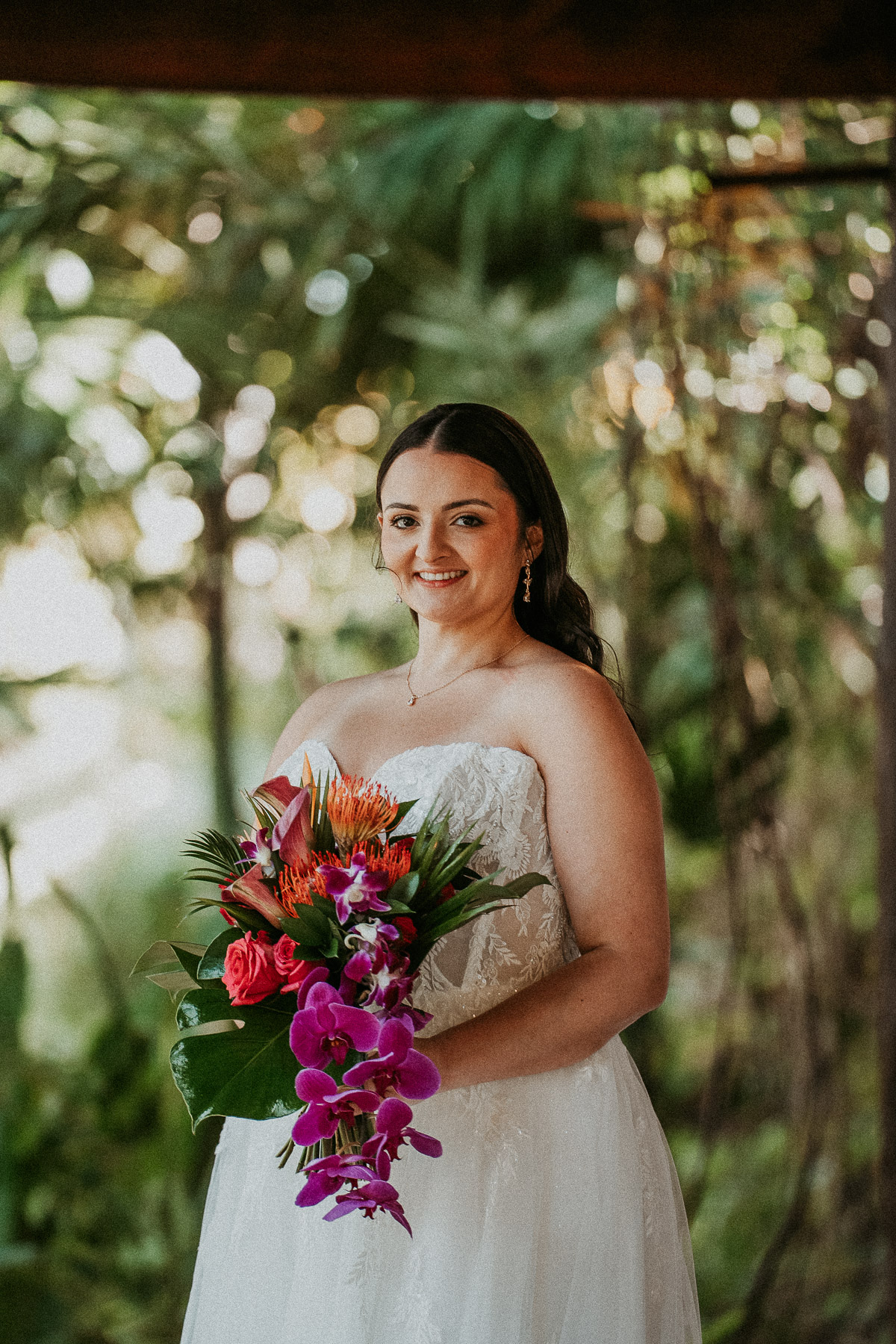 Bride smiling portrait surrounded by lush greenery at Hacienda Siesta Alegre