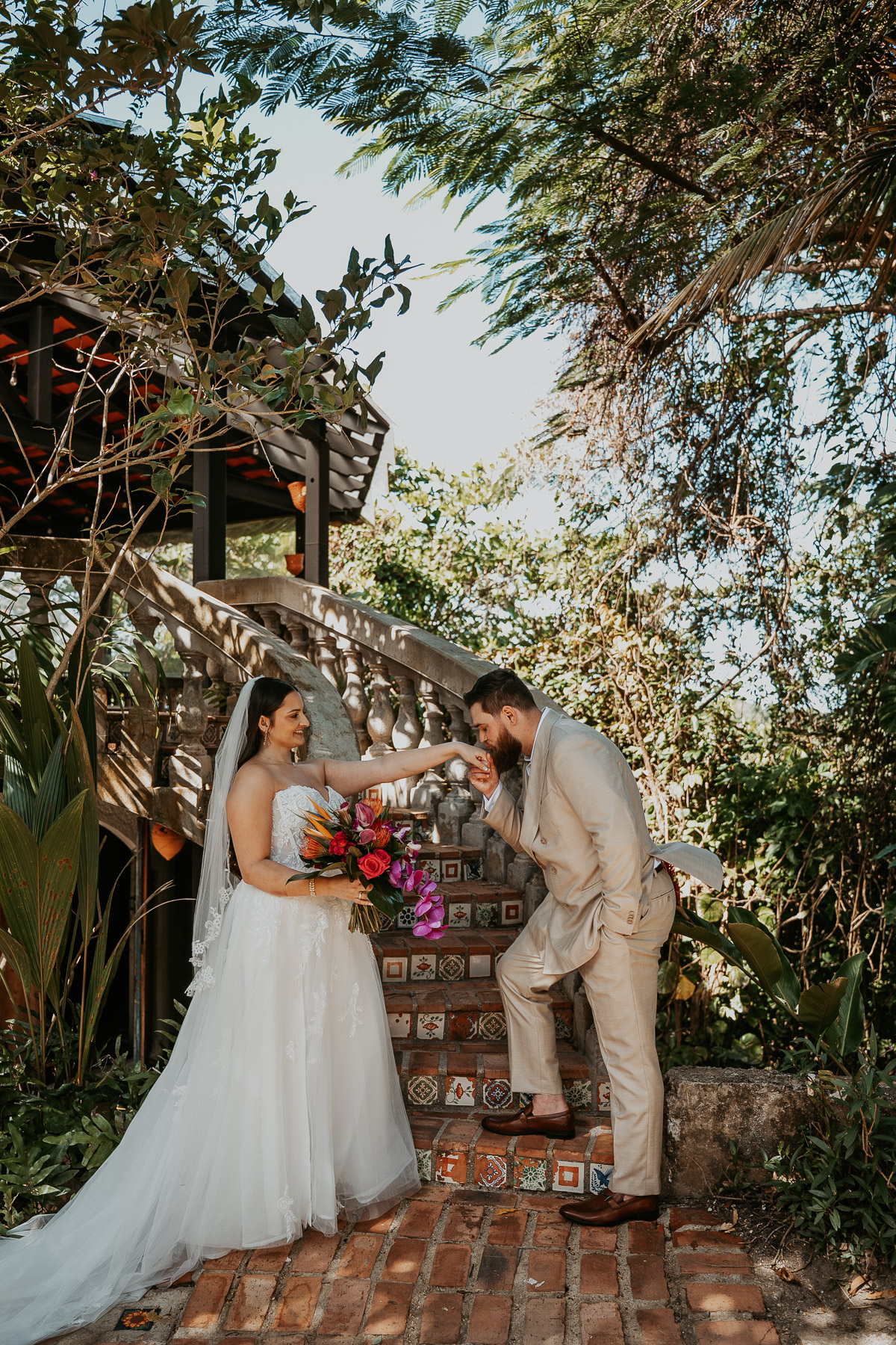 Couple posing together on the stairs at Hacienda Siesta Alegre