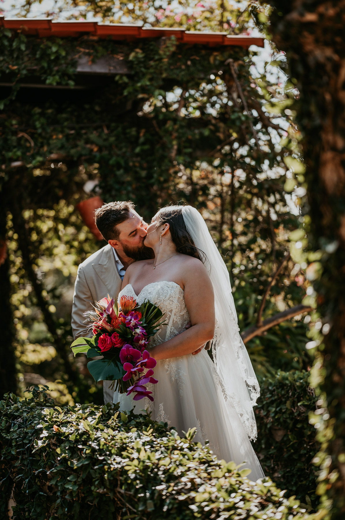 Couple sharing an intimate kiss during their wedding portraits