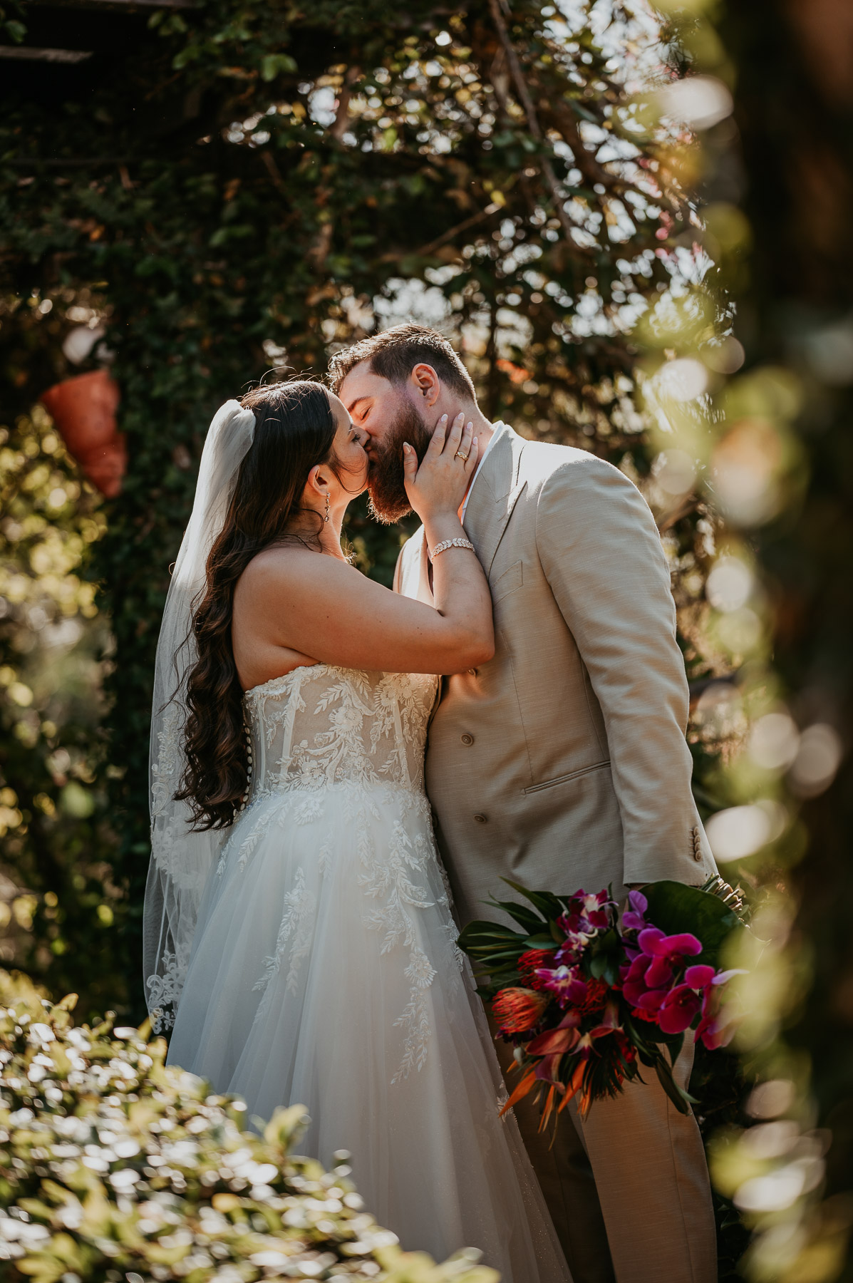 Couple sharing an intimate kiss during their wedding portraits