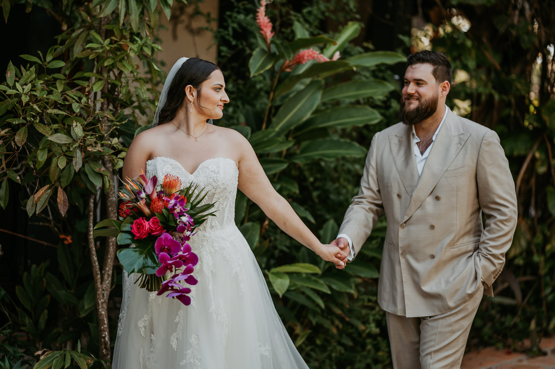 Newlyweds holding hands during portraits at Hacienda Siesta Alegre
