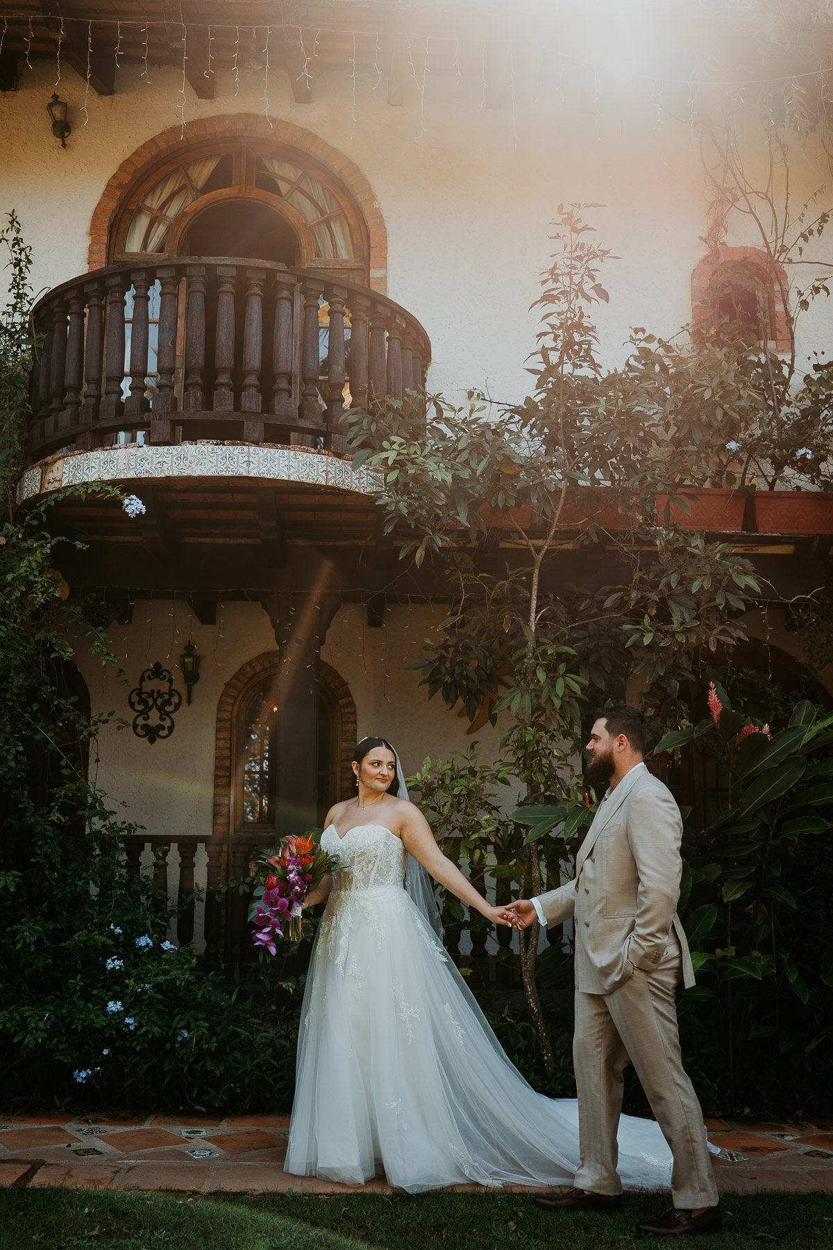 Newlyweds walking together across the grounds of Hacienda Siesta Alegre