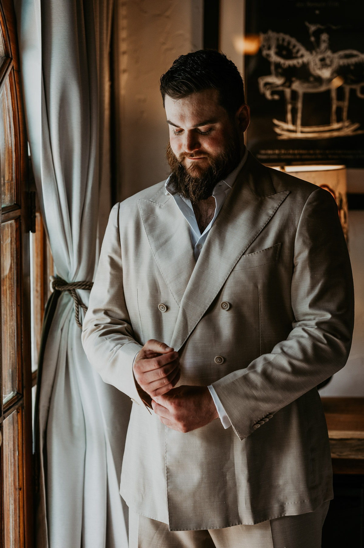 Groom adjusting his suit before the wedding ceremony