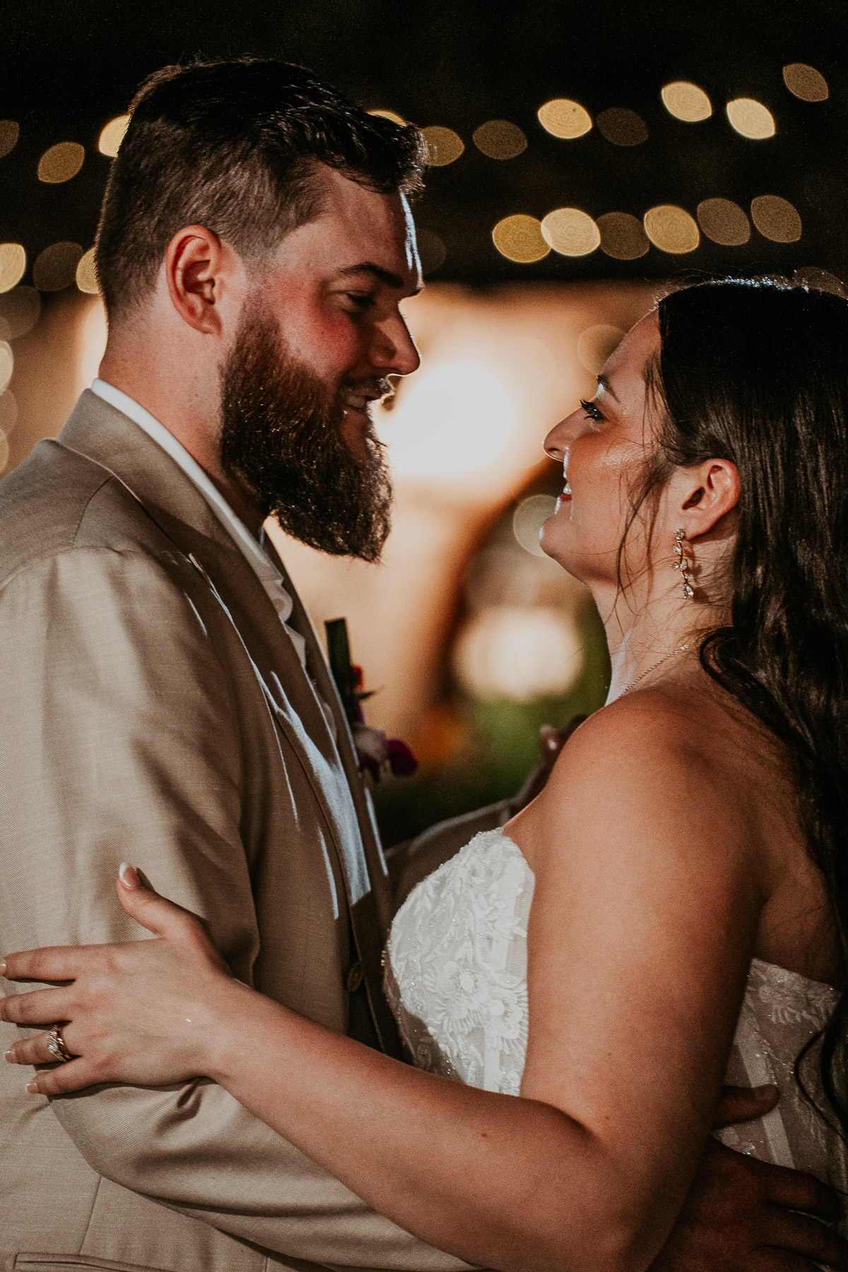 Couple sharing their first dance surrounded by wedding guests
