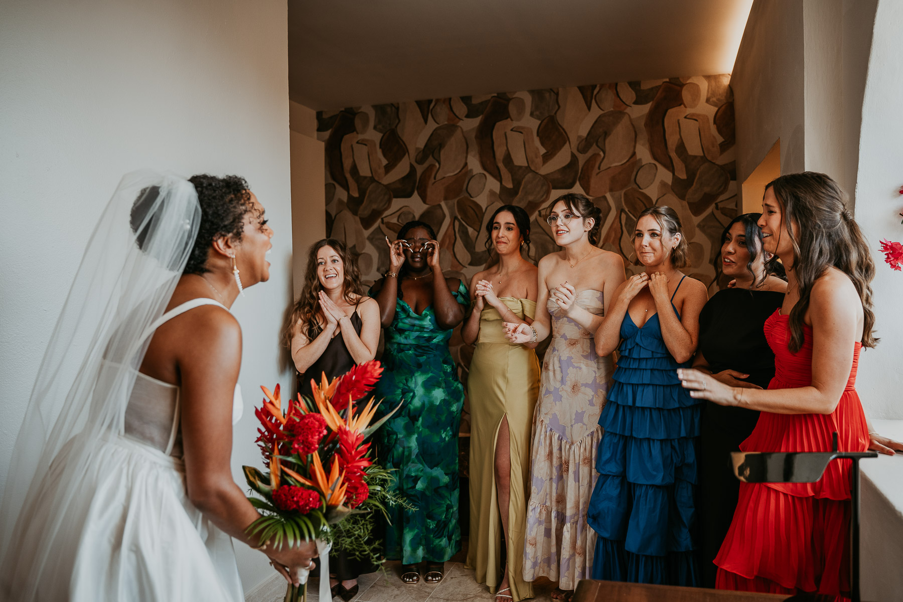 A candid moment of the bride and bridesmaids during their first look.