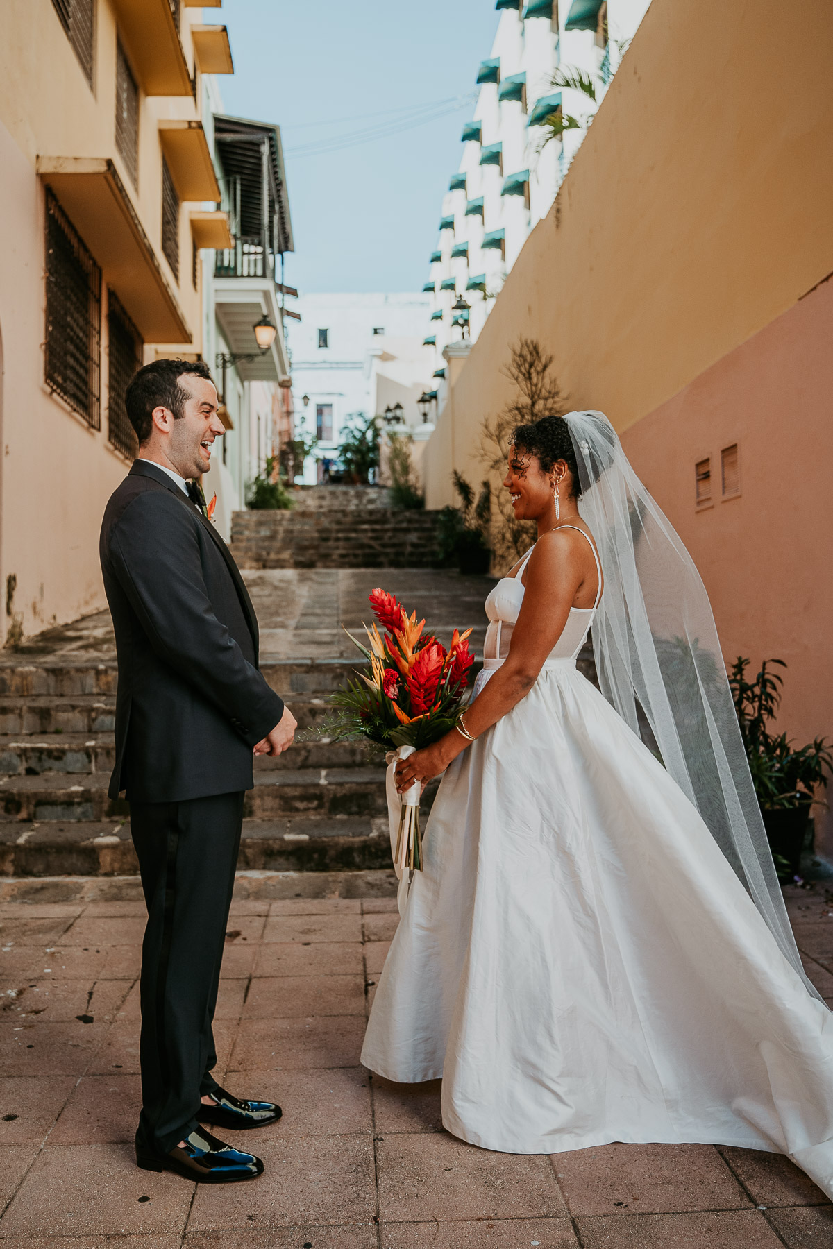 First look between the bride and groom on the stairs of Callejon de las Monjas.