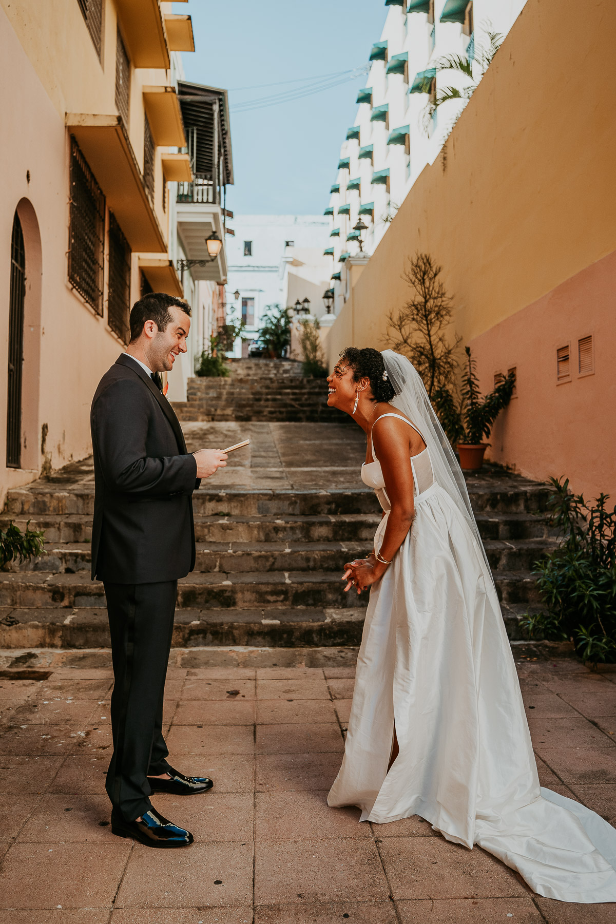 First look between the bride and groom on the stairs of Callejon de las Monjas.