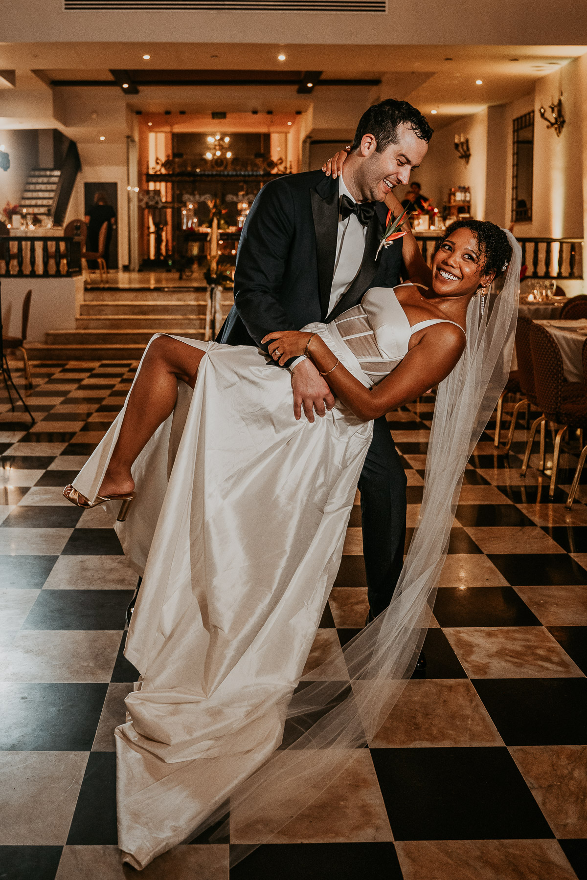 Bride and groom sharing their first dance under the chandeliers of Salon Campeche.