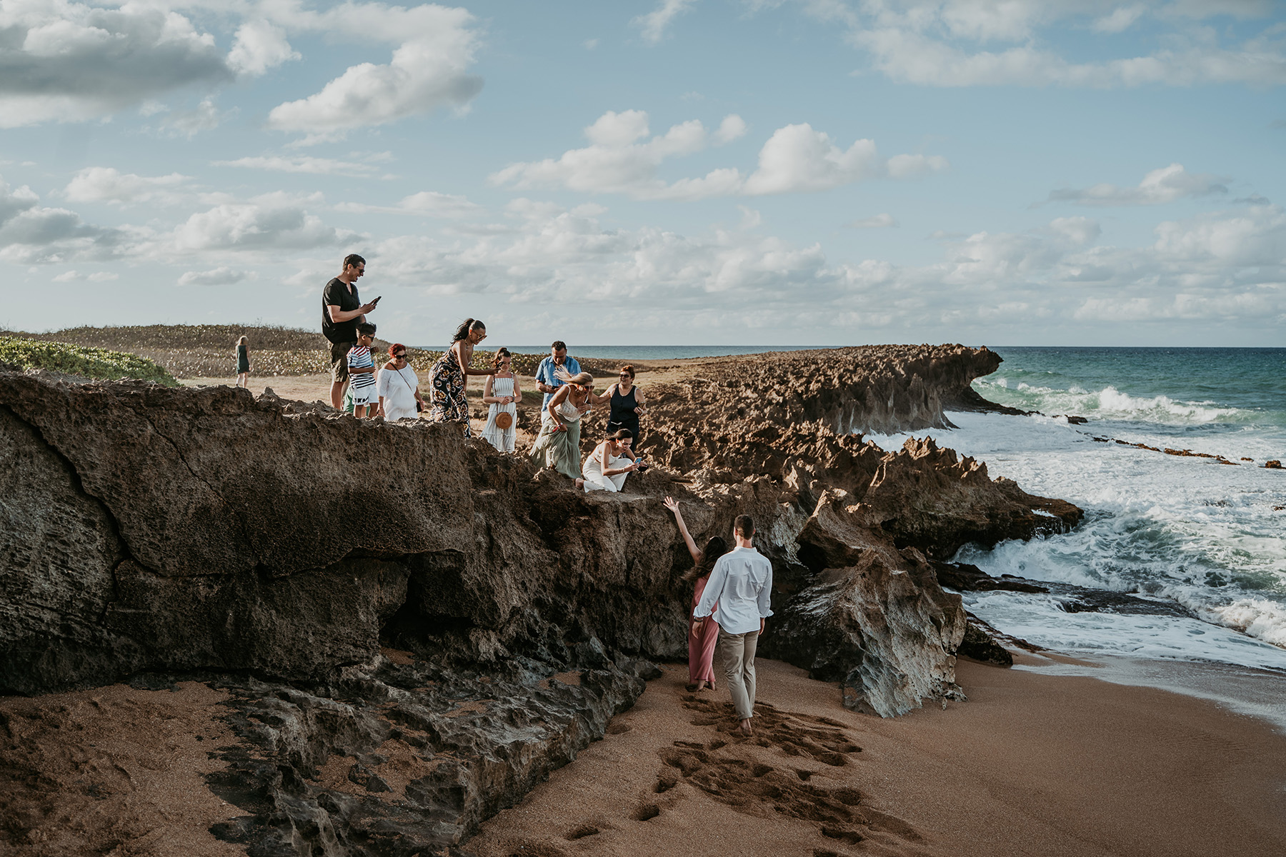 Stunning Puerto Rico beach proposal captured with family watching in the distance.