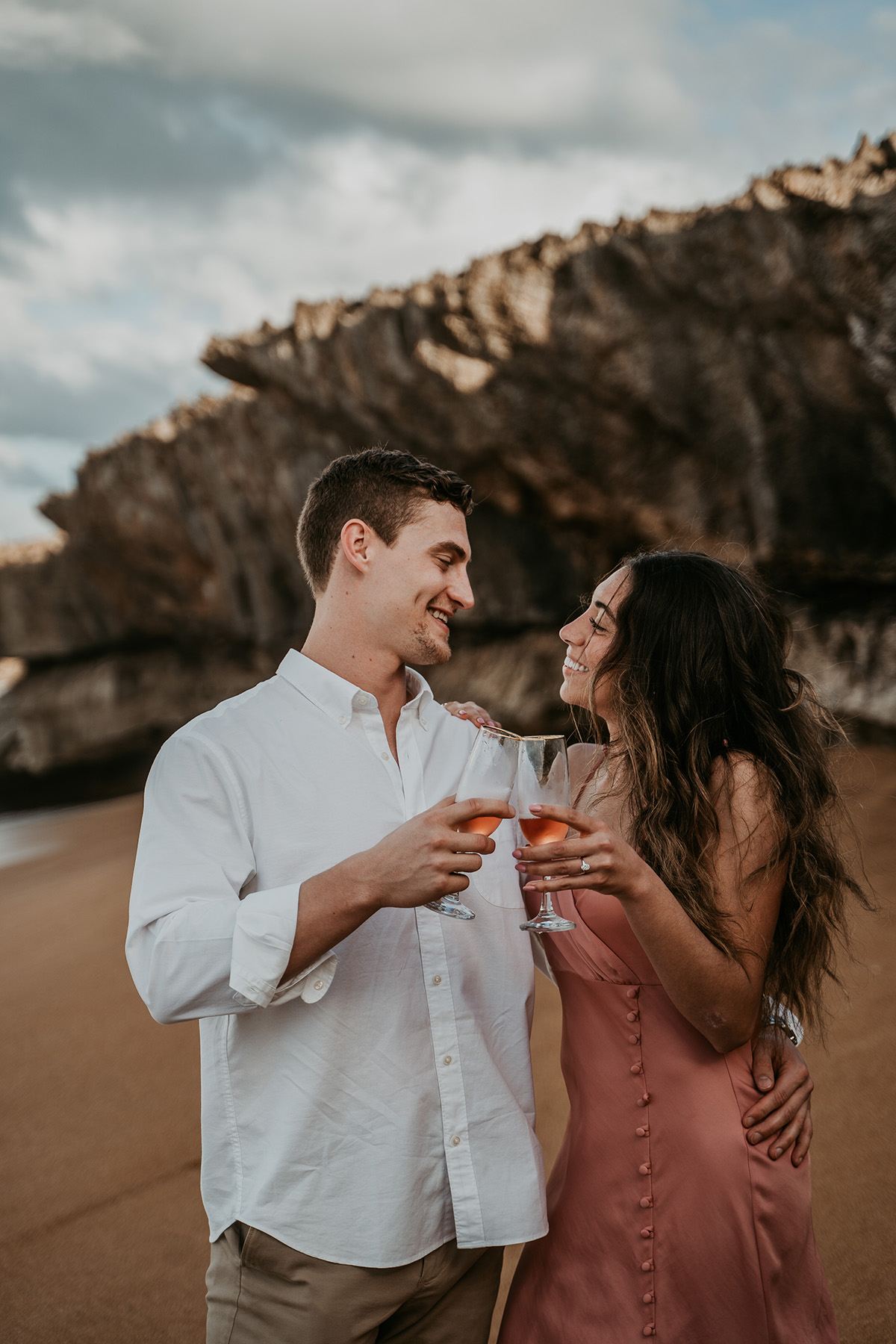 Couple opening champagne to celebrate proposal in Puerto Rico.