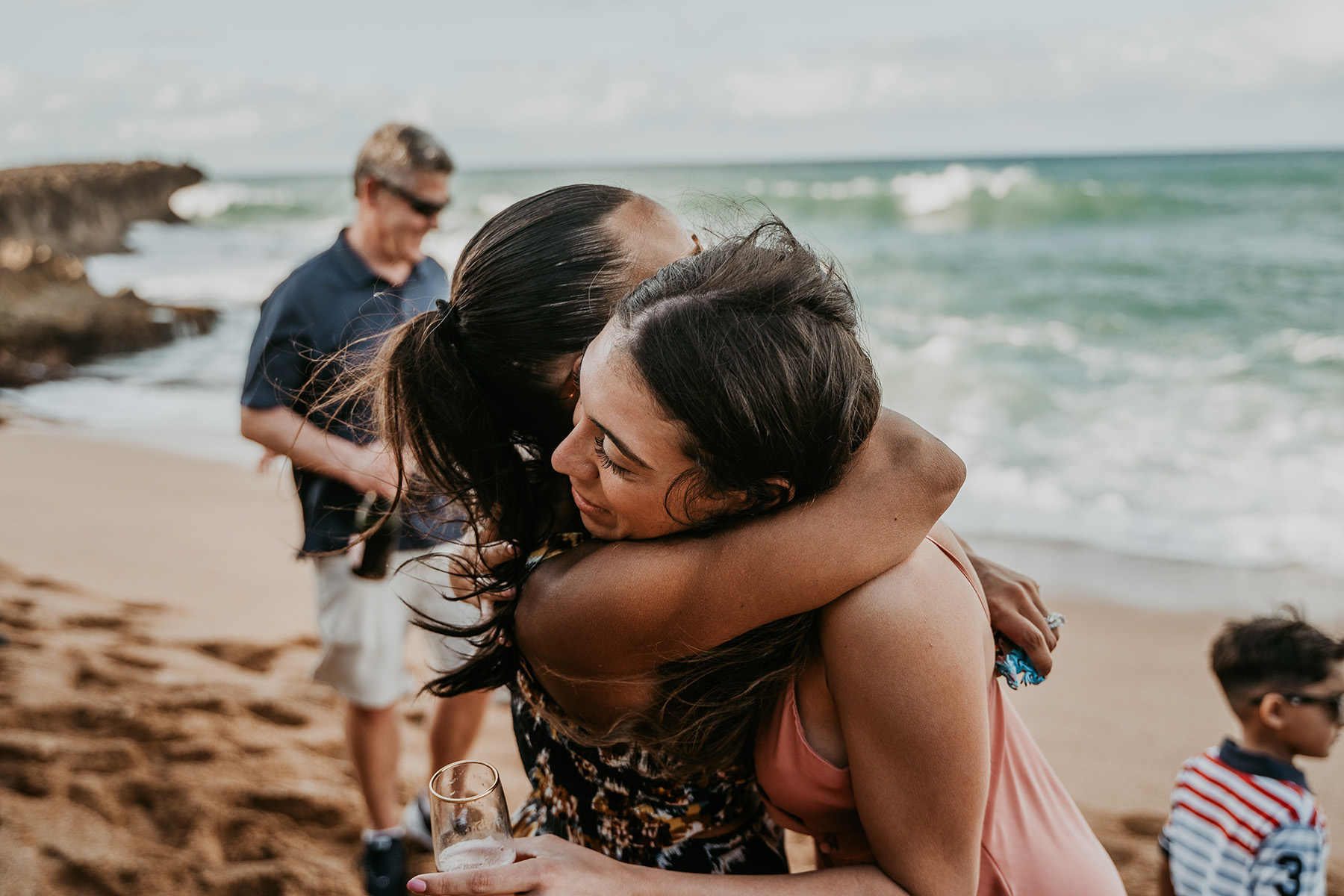 Stunning Puerto Rico beach proposal captured with family watching in the distance.