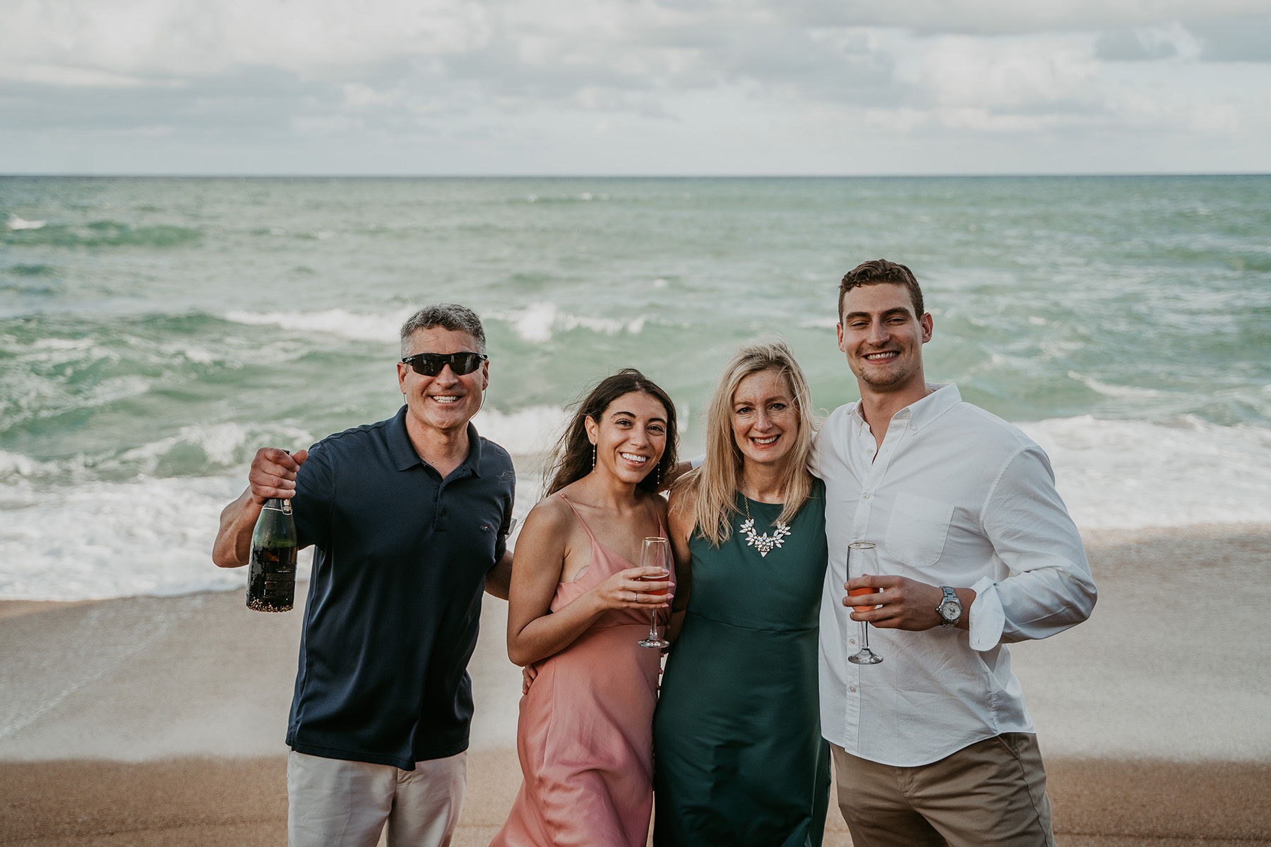 Stunning Puerto Rico beach proposal captured with family watching in the distance.