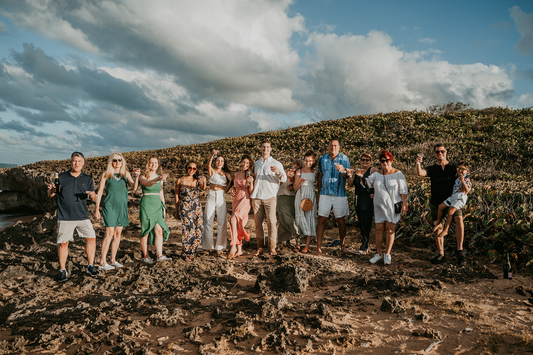 Stunning Puerto Rico beach proposal captured with family watching in the distance.