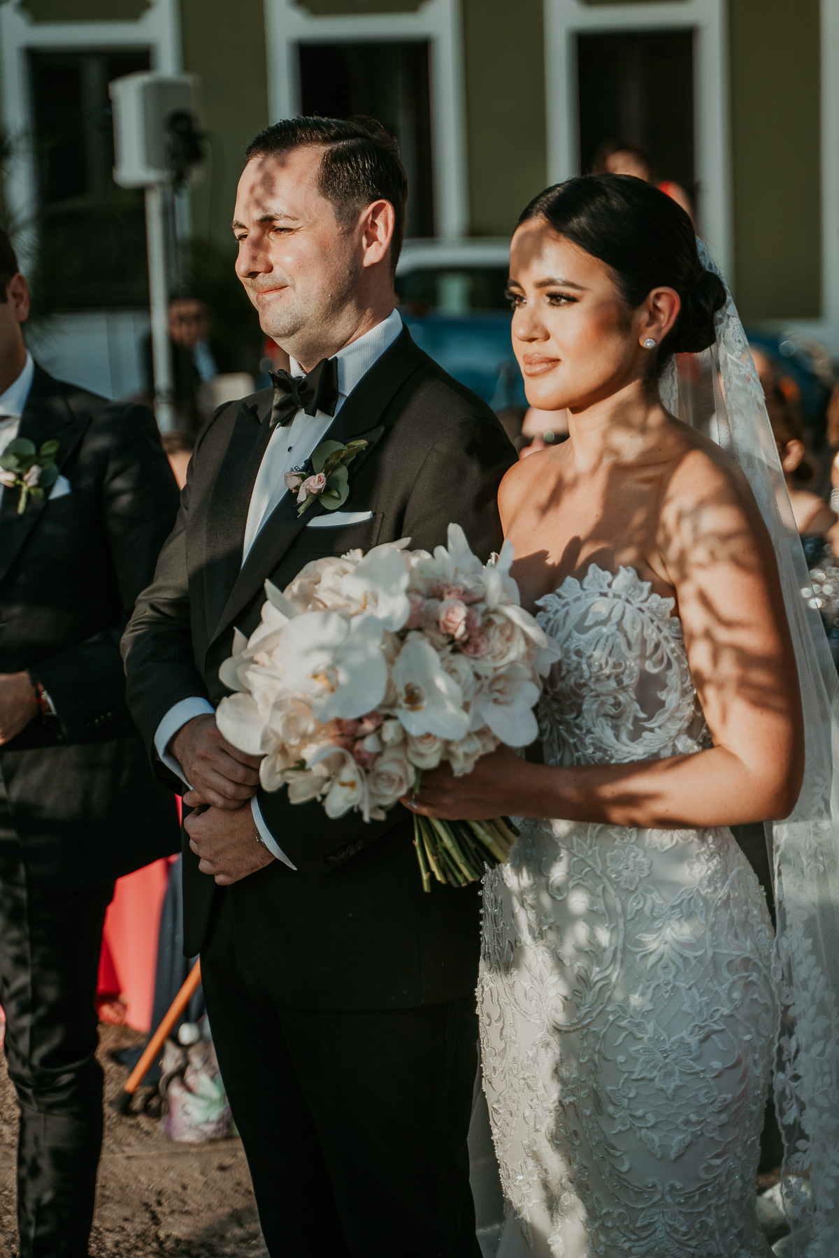 Outdoor wedding ceremony at La Rogativa, overlooking San Juan Bay with historic bronze statue in Old San Juan.