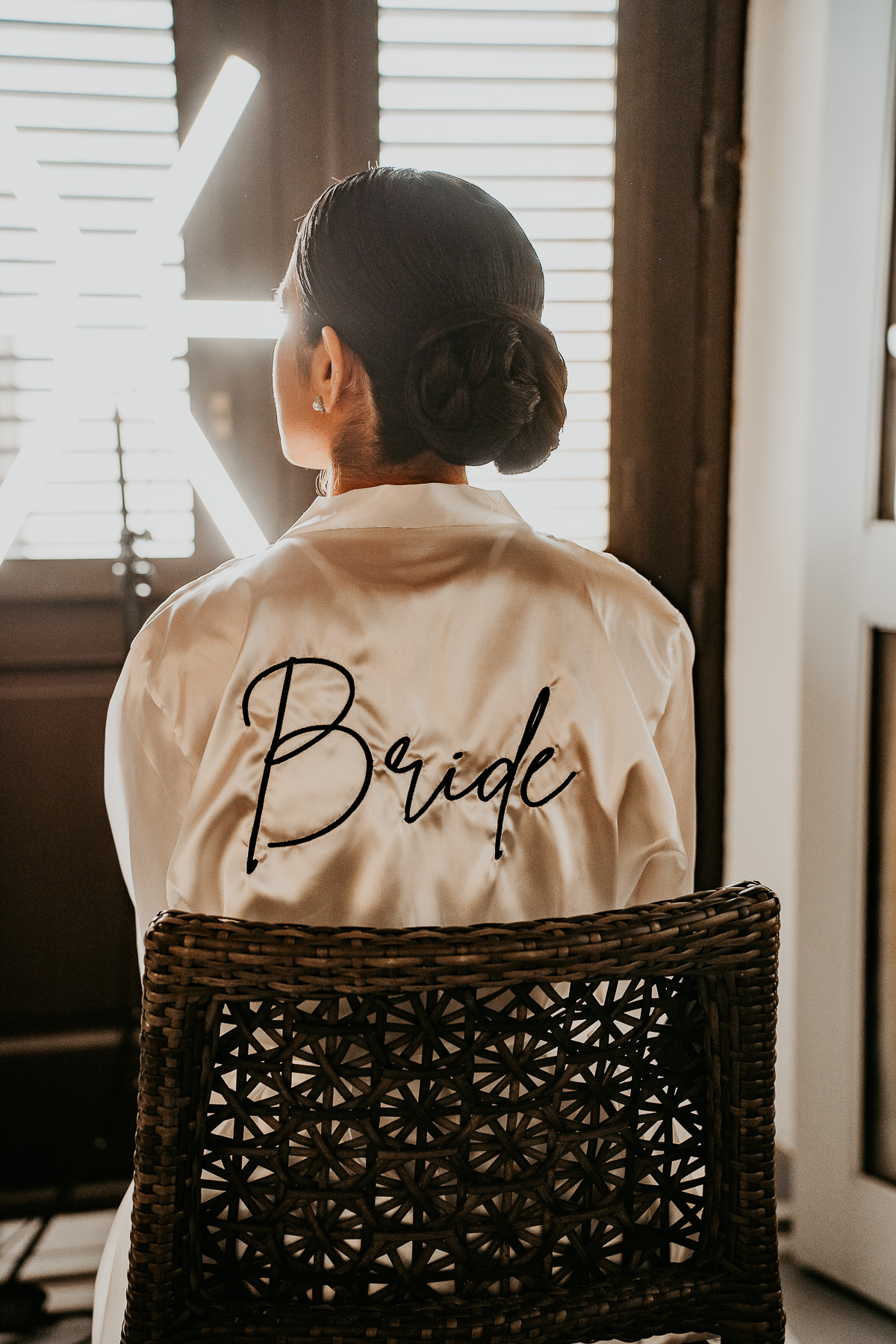 Candid photo of bride during hair and makeup.