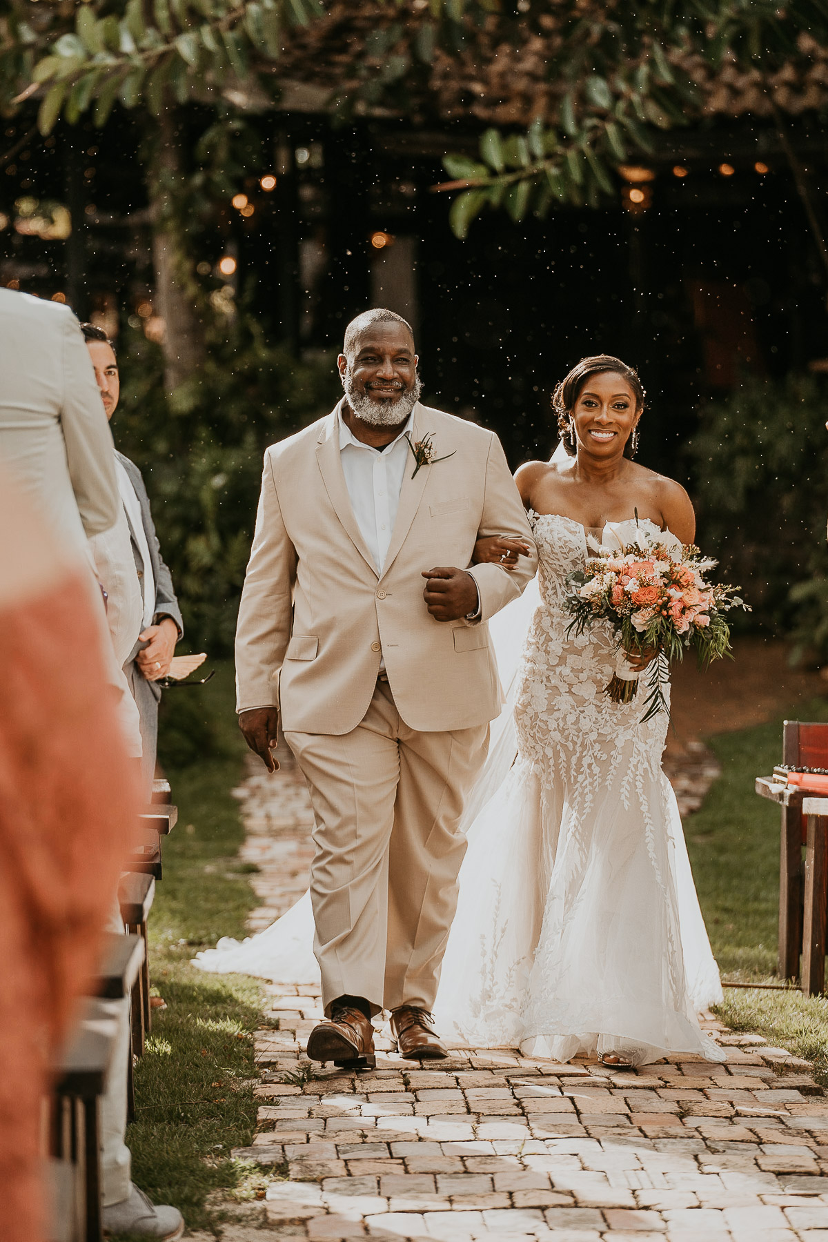 Rain drops fall while bride walks down the Isle at Hacienda Siesta Alegre Wedding.