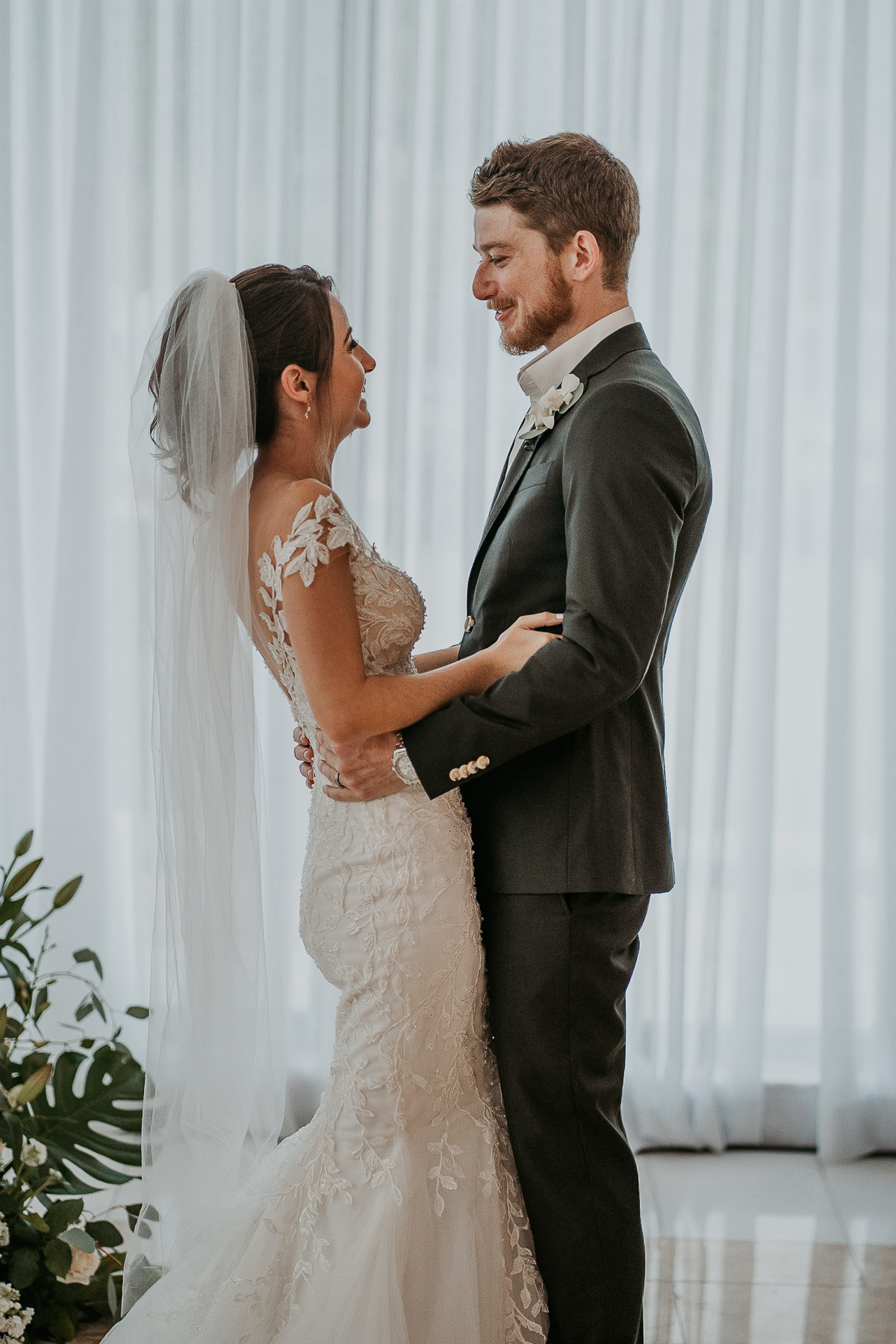 Bride and groom celebrating their indoor wedding ceremony at the Hyatt Regency Grand Reserve with joyful smiles.