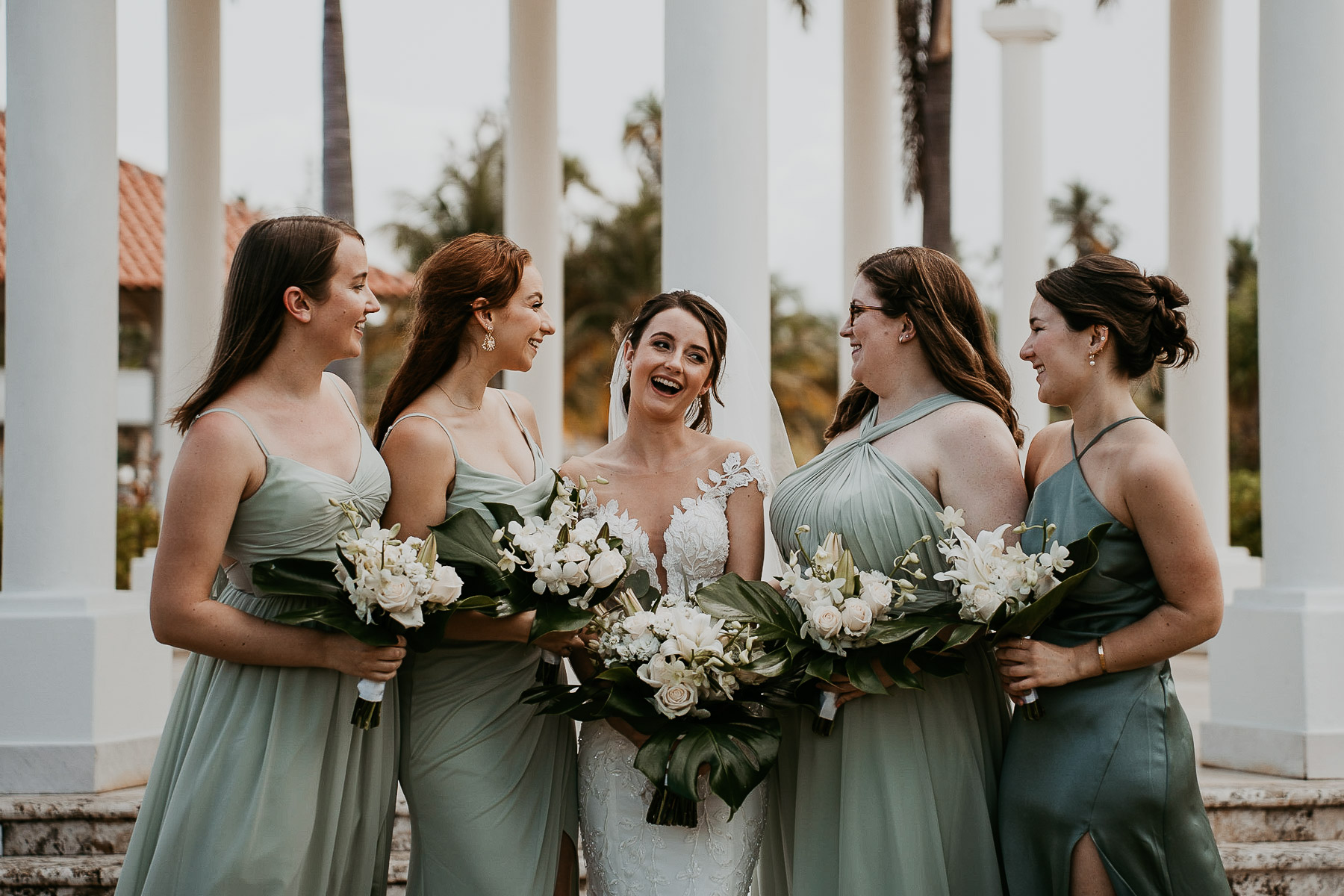 Bridesmaids laughing with bride at the gardens of the First kiss at Indoor ceremony at Hyatt Regency Grand Reserve Wedding.