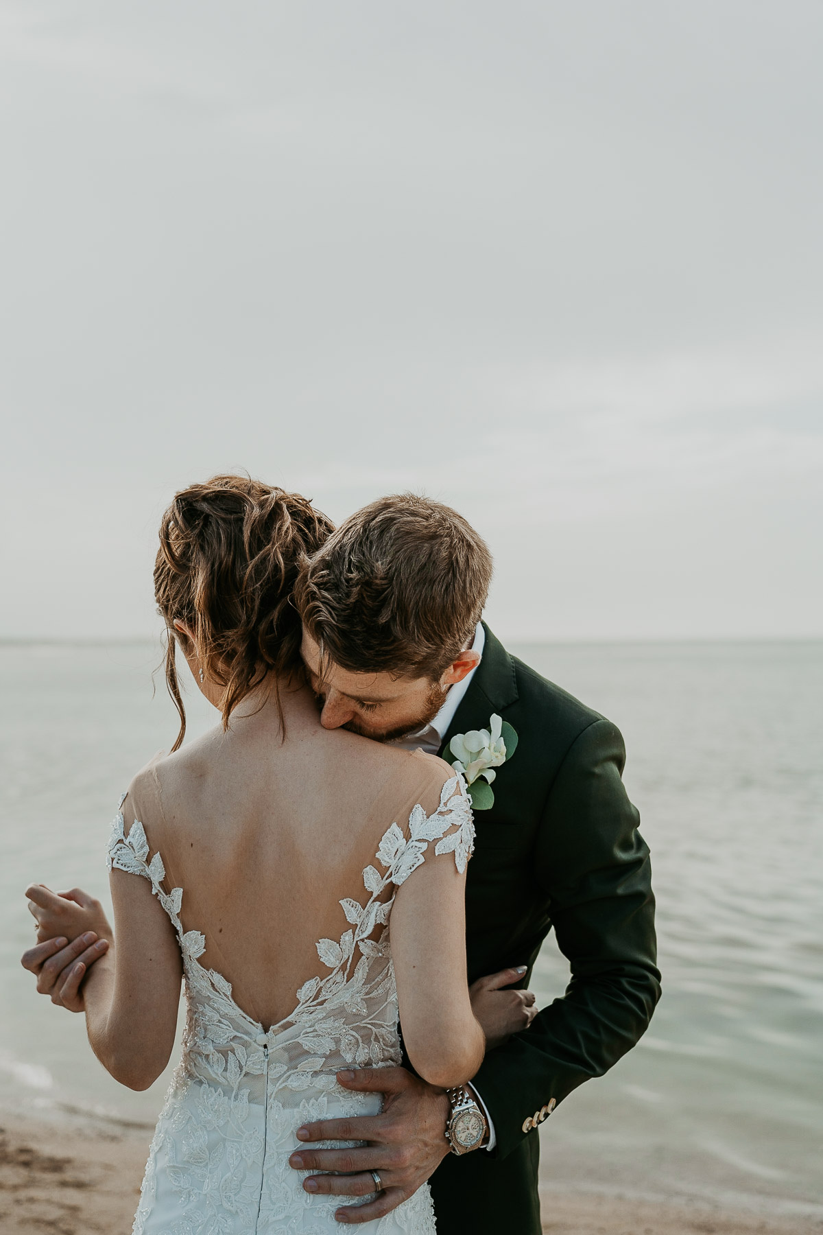 Newlyweds posing for photos outdoors at the Hyatt Regency Grand Reserve after the rain cleared, capturing the ocean and clear sky.