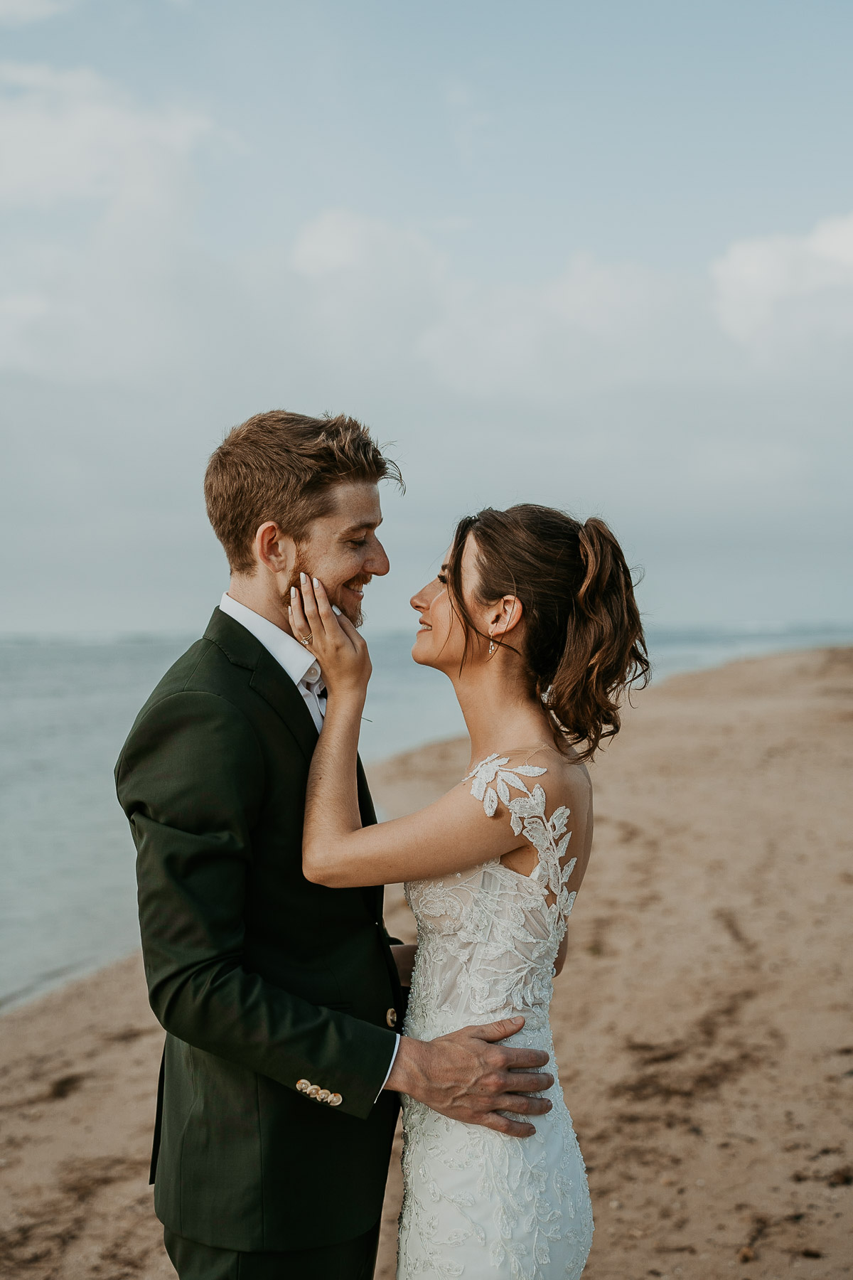 Newlyweds posing for photos outdoors at the Hyatt Regency Grand Reserve after the rain cleared, capturing the ocean and clear sky.