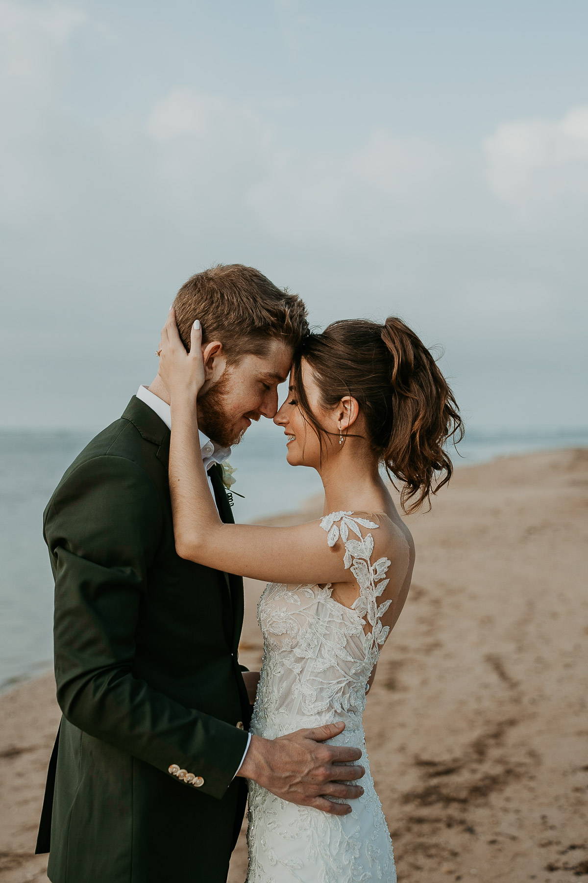 Newlyweds posing for photos outdoors at the Hyatt Regency Grand Reserve after the rain cleared, capturing the ocean and clear sky.