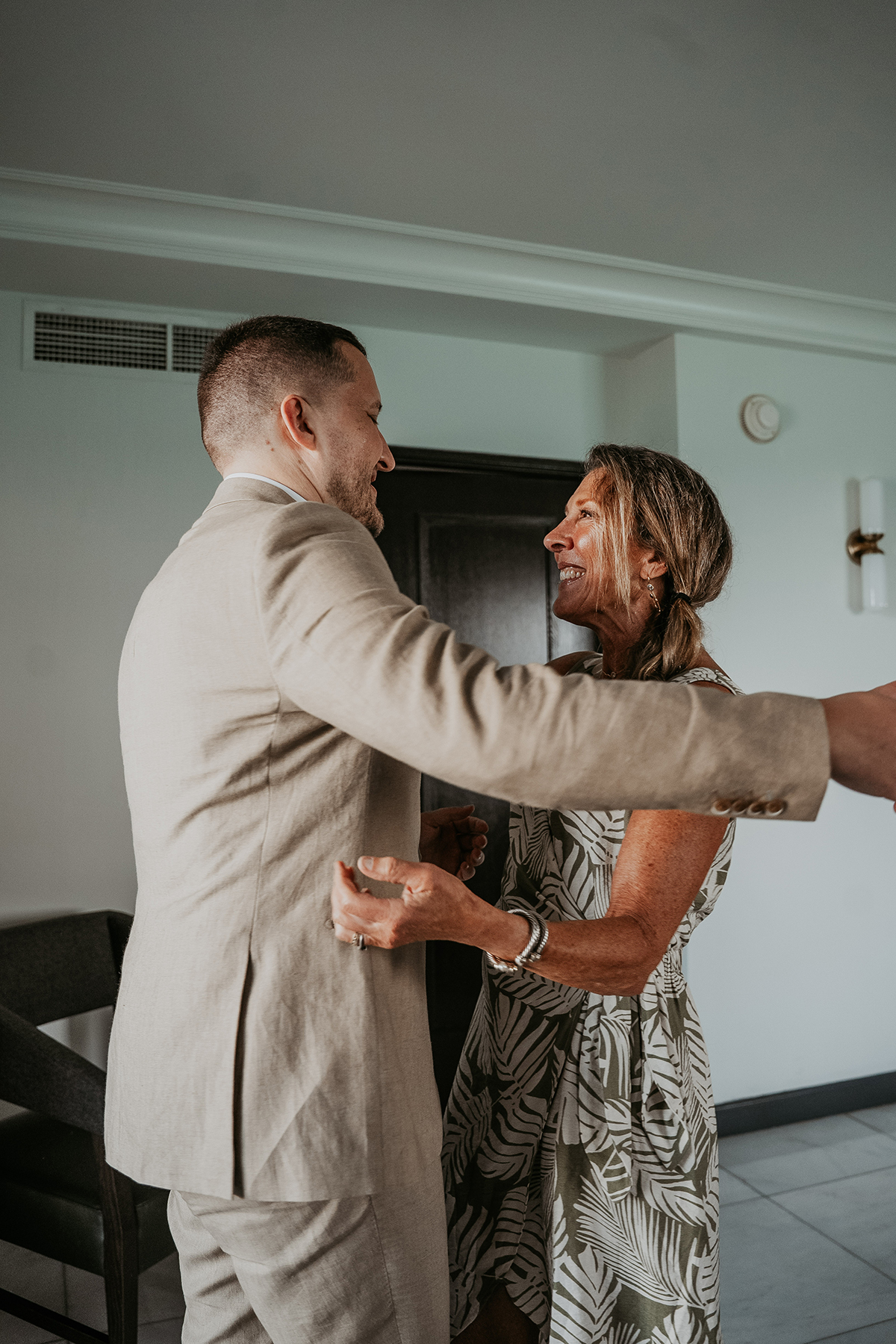 n emotional reaction as a mother sees her son dressed for his wedding.