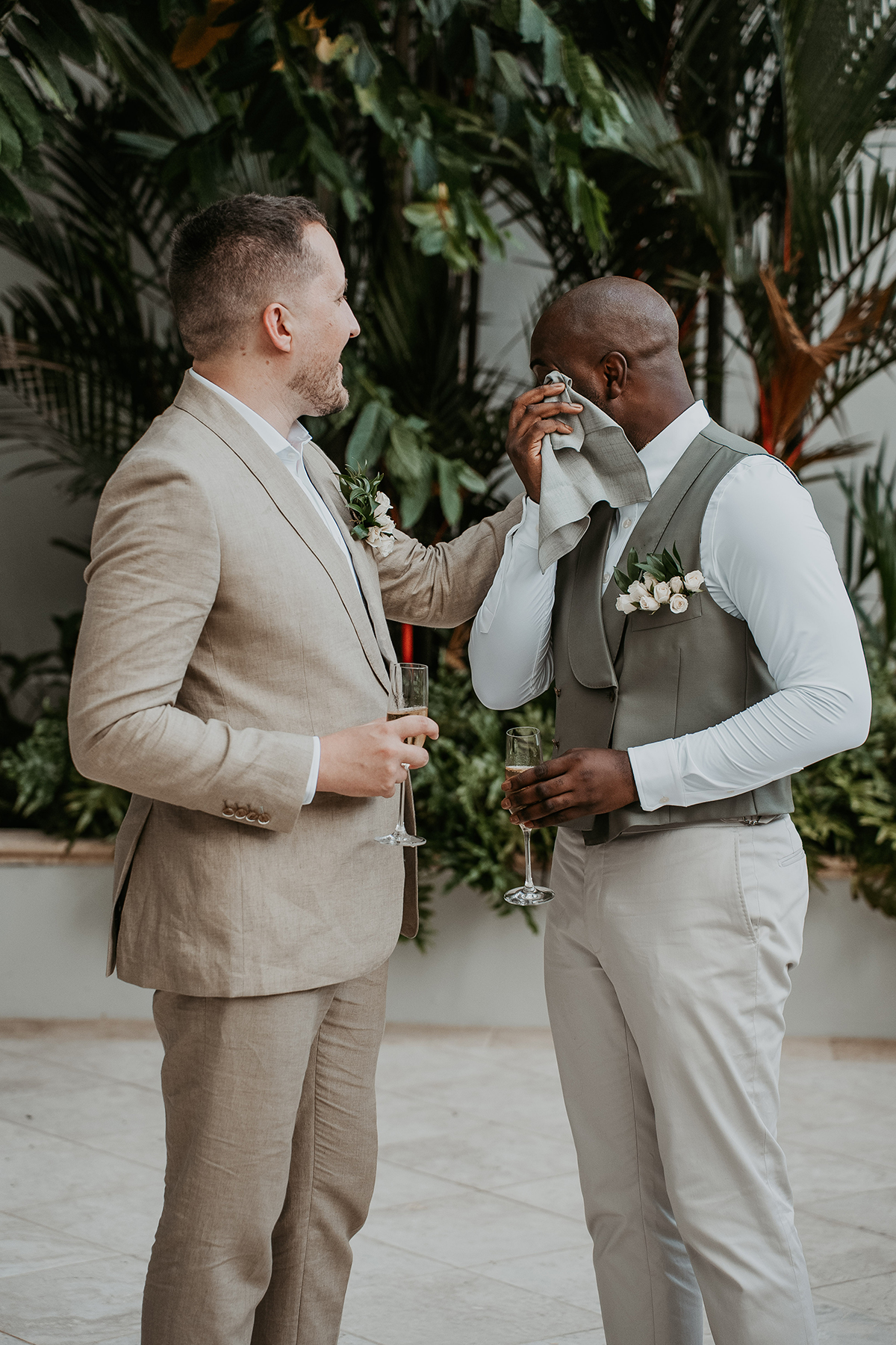 A gay couple share a candid intimate moment together before the ceremony.