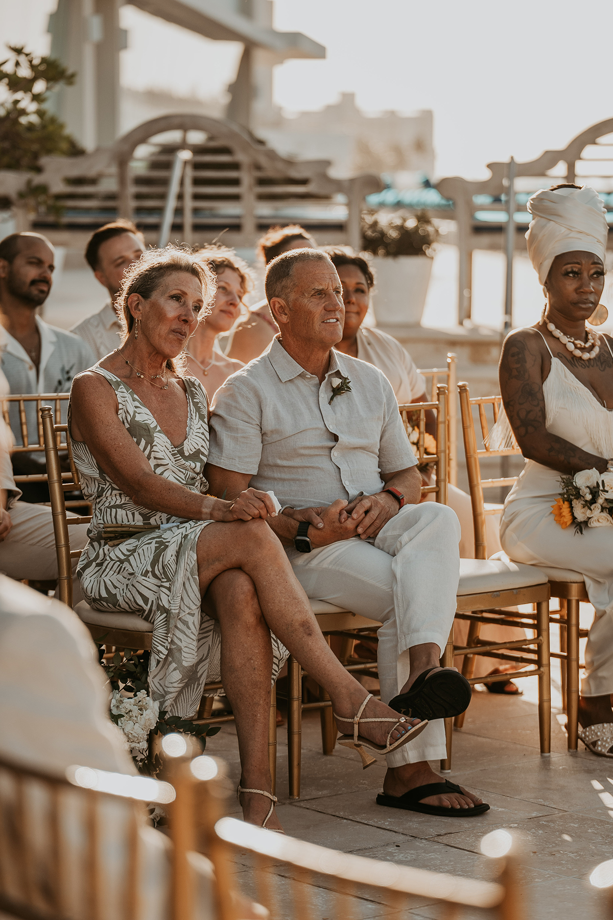 Guests watch as the two grooms exchange vows during their wedding ceremony.