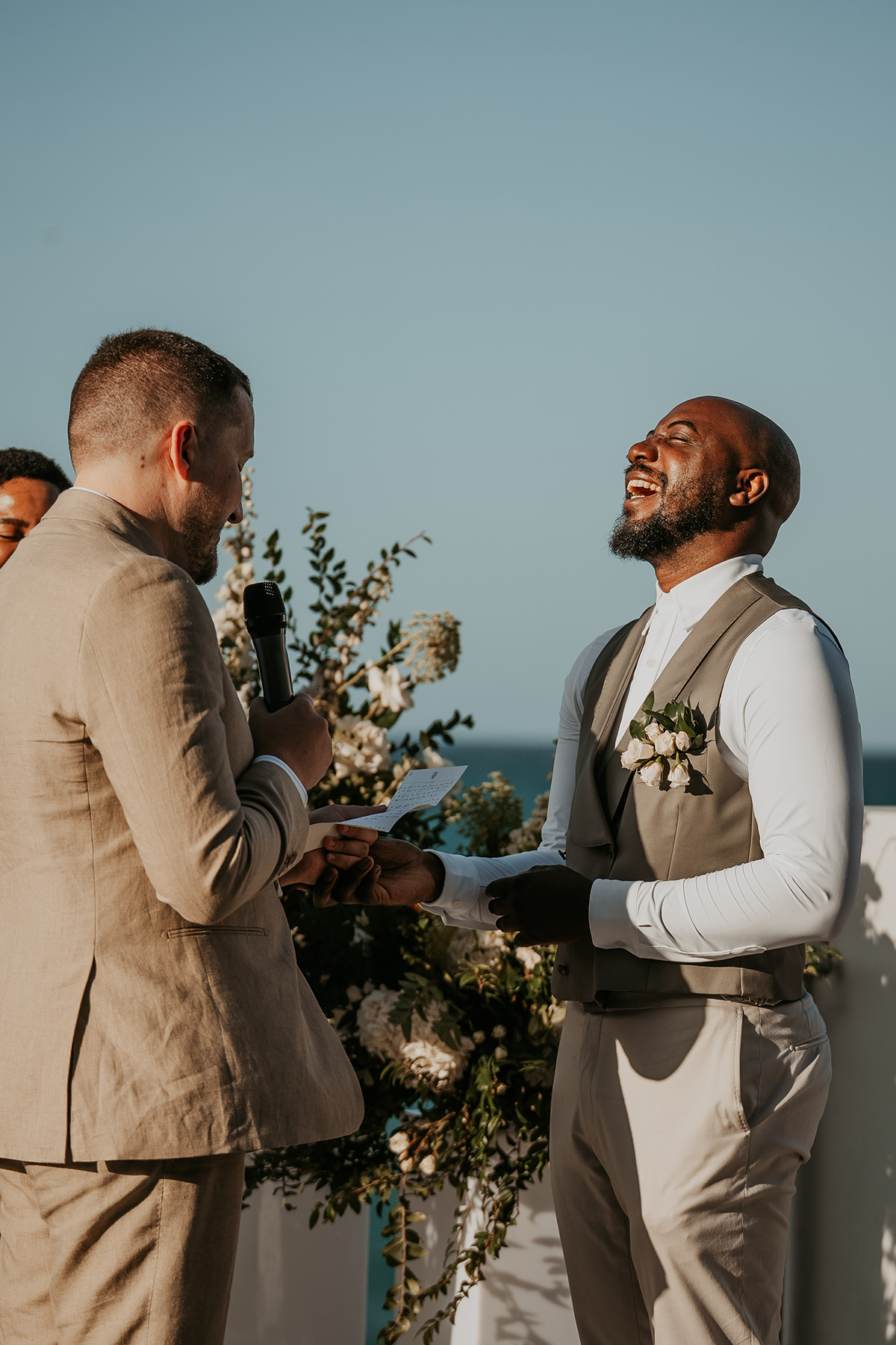 Two grooms exchange wedding vows during an intimate ceremony in Puerto Rico.