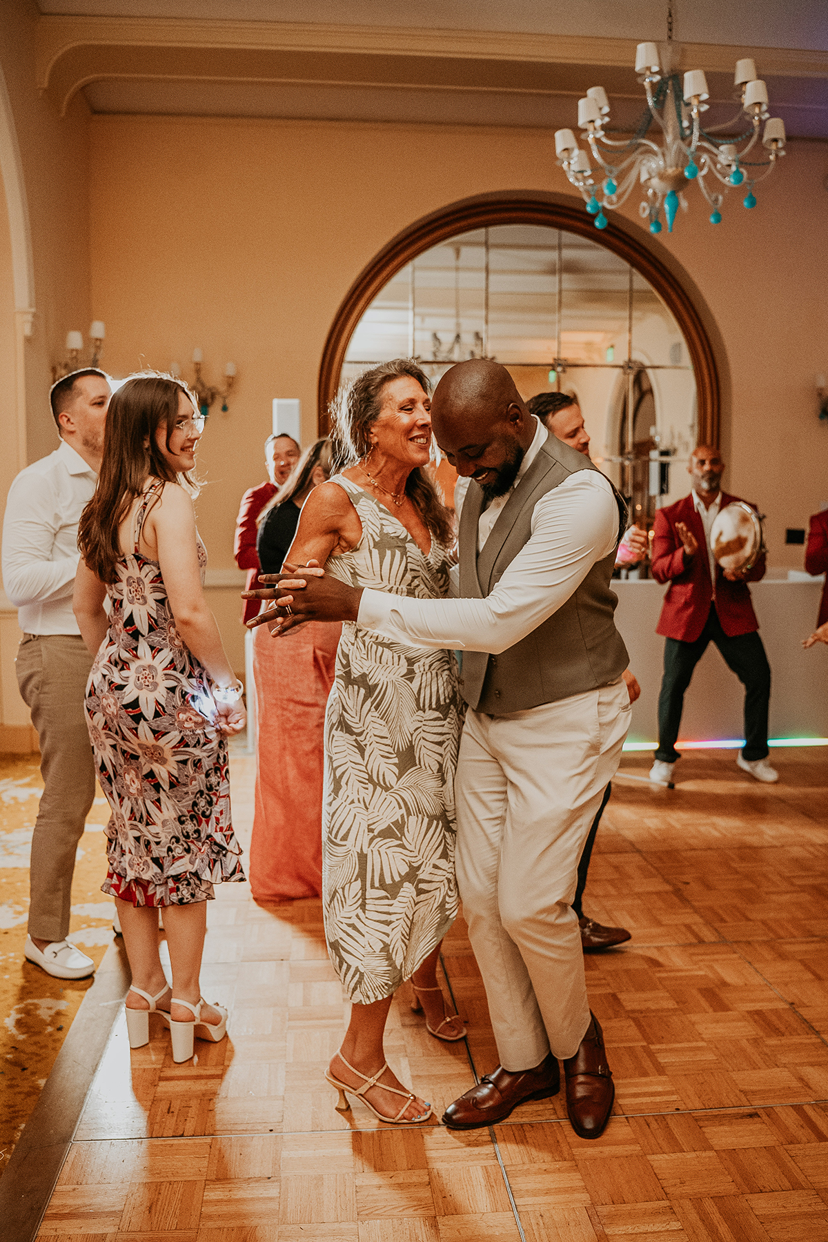 One groom dancing with mother in law during wedding celebration. 