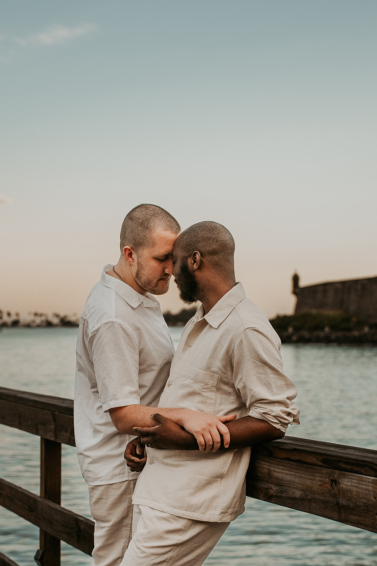 An interracial gay couple poses together during an early-morning wedding portrait session in Old San Juan.