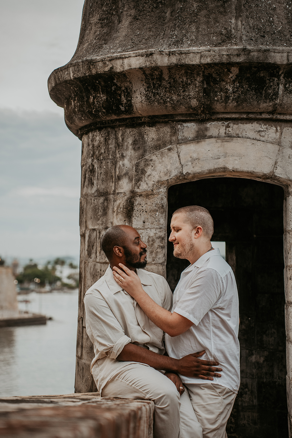 Wedding portraits of an interracial gay couple surrounded by Old San Juan's colorful colonial architecture.