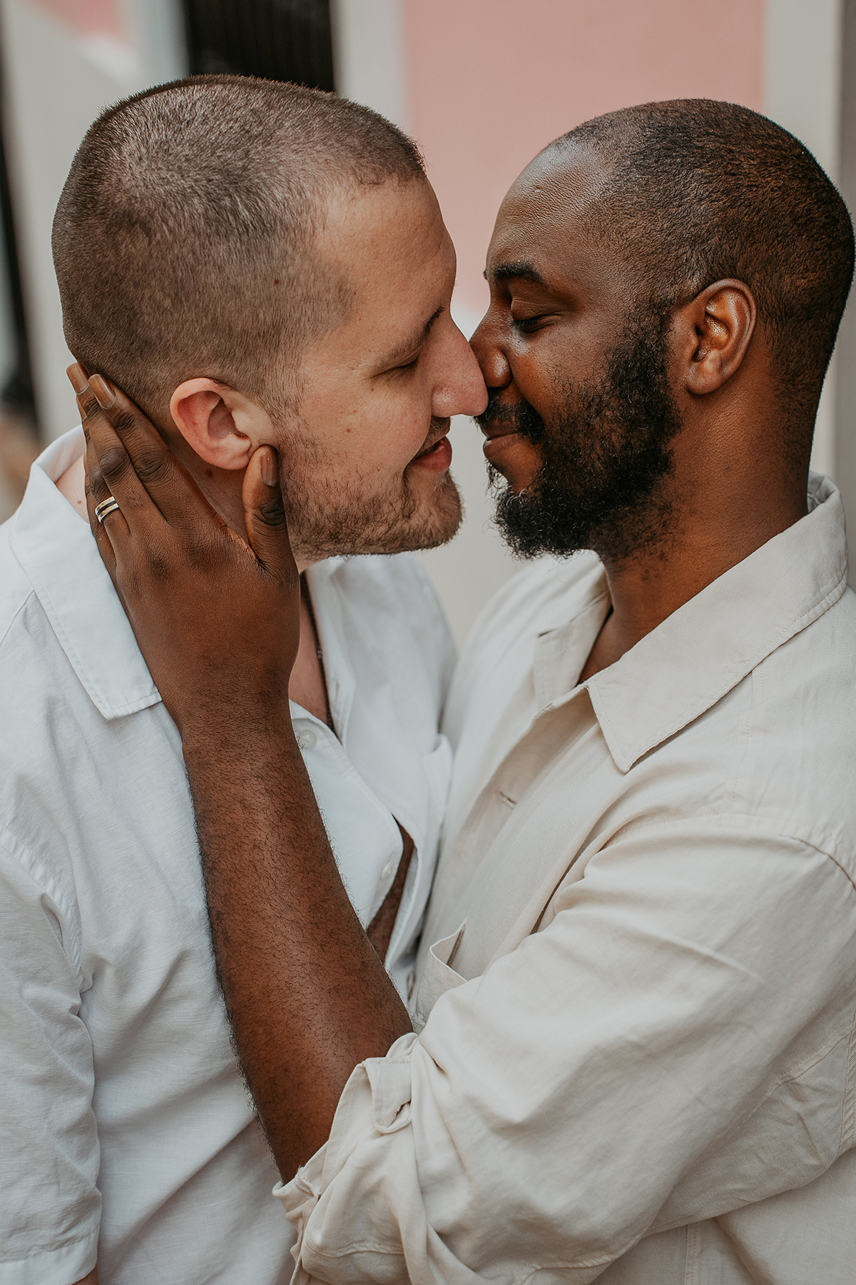 Two grooms share an affectionate moment during their wedding portrait session in historic Old San Juan, Puerto Rico.