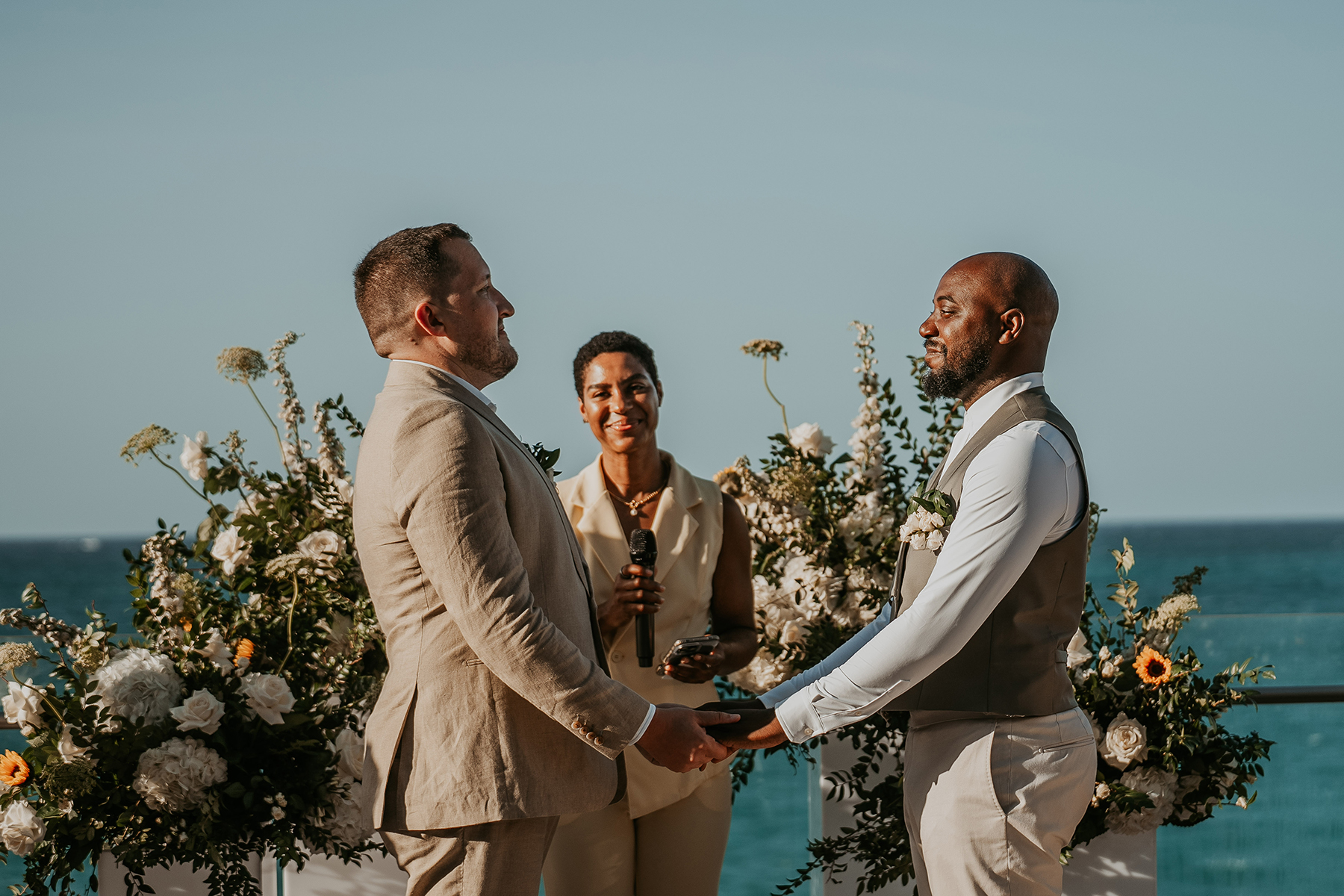 An affectionate glance between the grooms during their wedding ceremony.